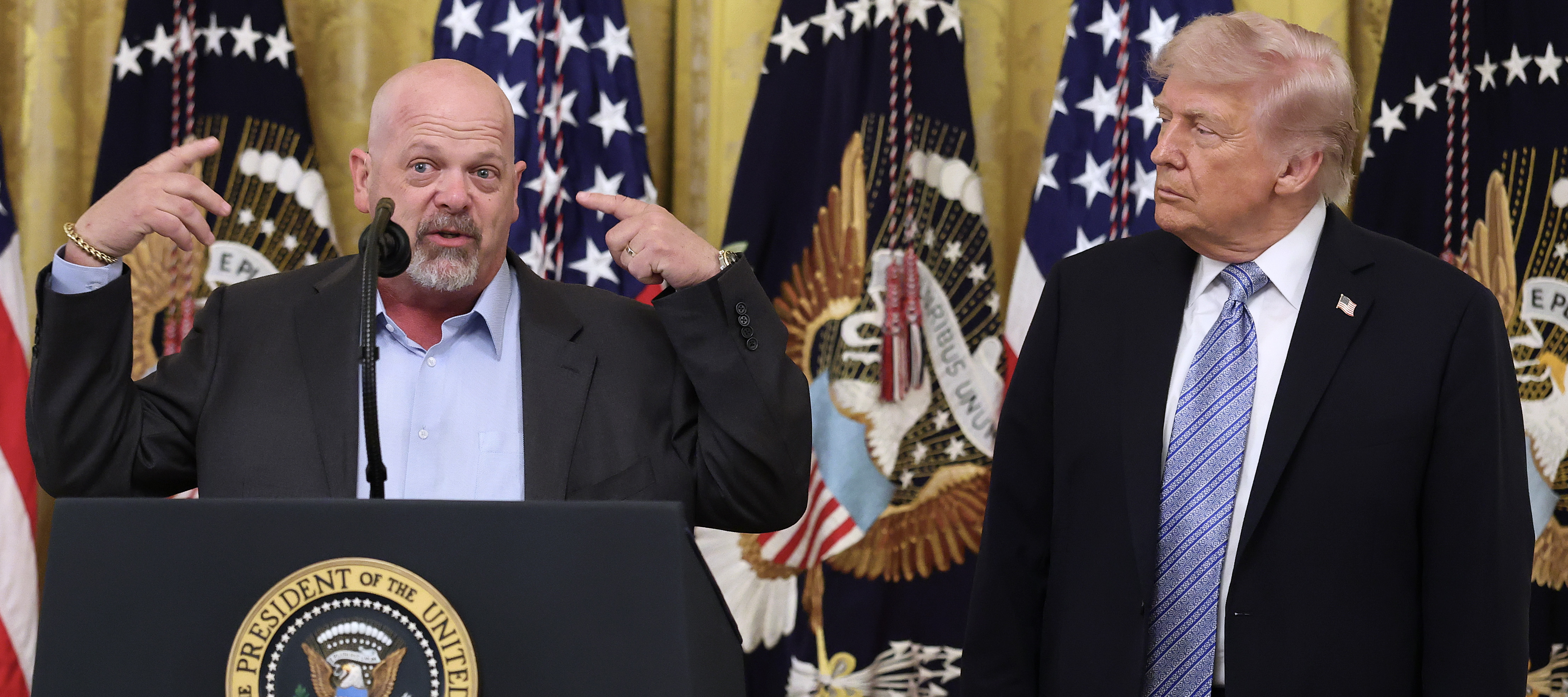 Pawn Stars personality Rick Harrison gestures broadly at the White House as President Donald Trump looks on.