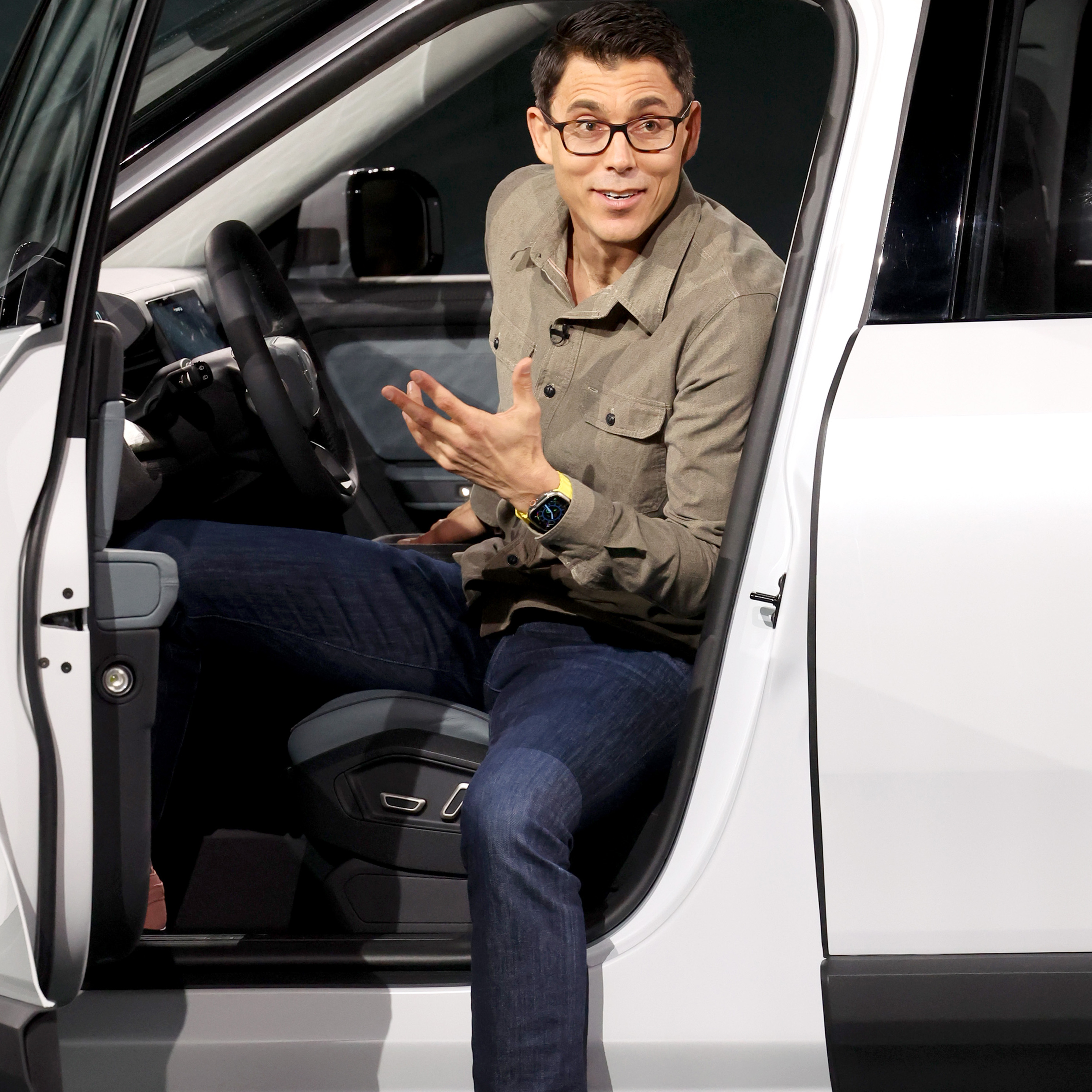 Rivian CEO RJ Scaringe sits inside the Rivian R2 electric vehicle.