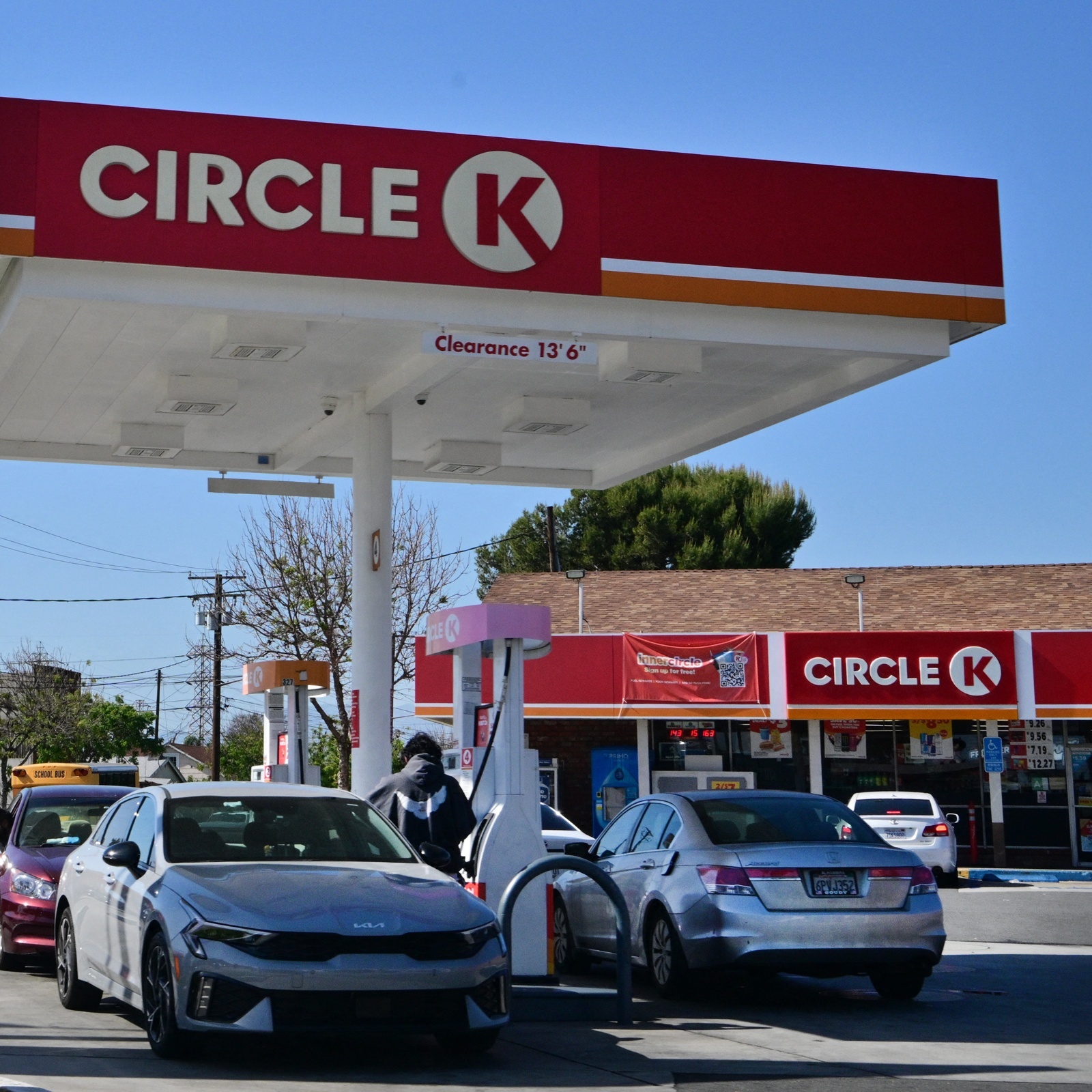 Cars sit in a Circle K gas station with prices clearly visible