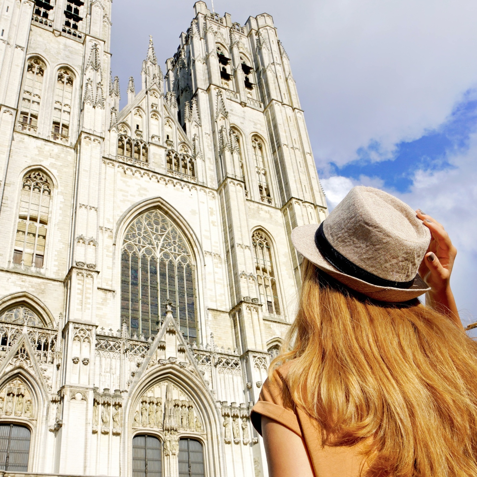 A woman looks up at Brussels Cathedral in Brussels, Belgium.
