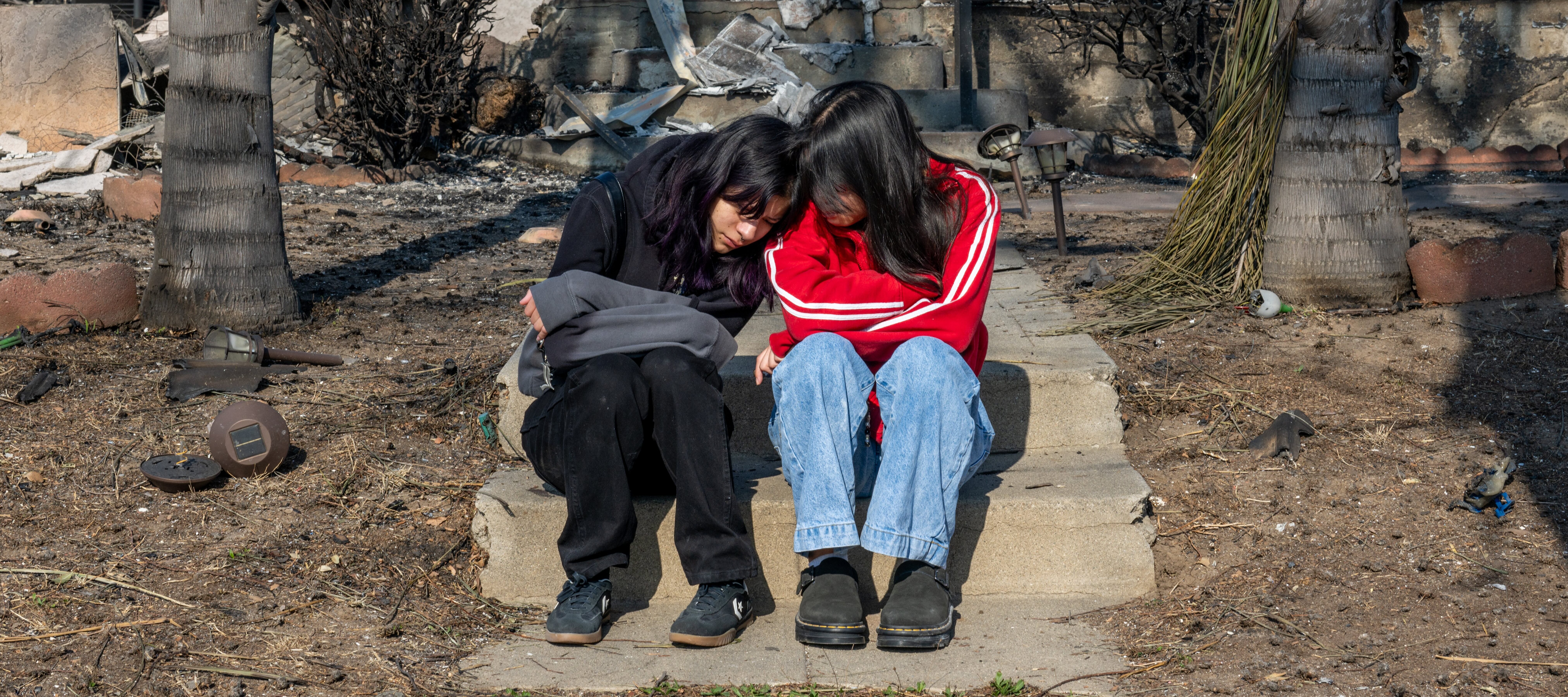 Sisters Emilee and Natalee De Santiago mourn the loss of their home in Altadena, Cali. in January 2025.