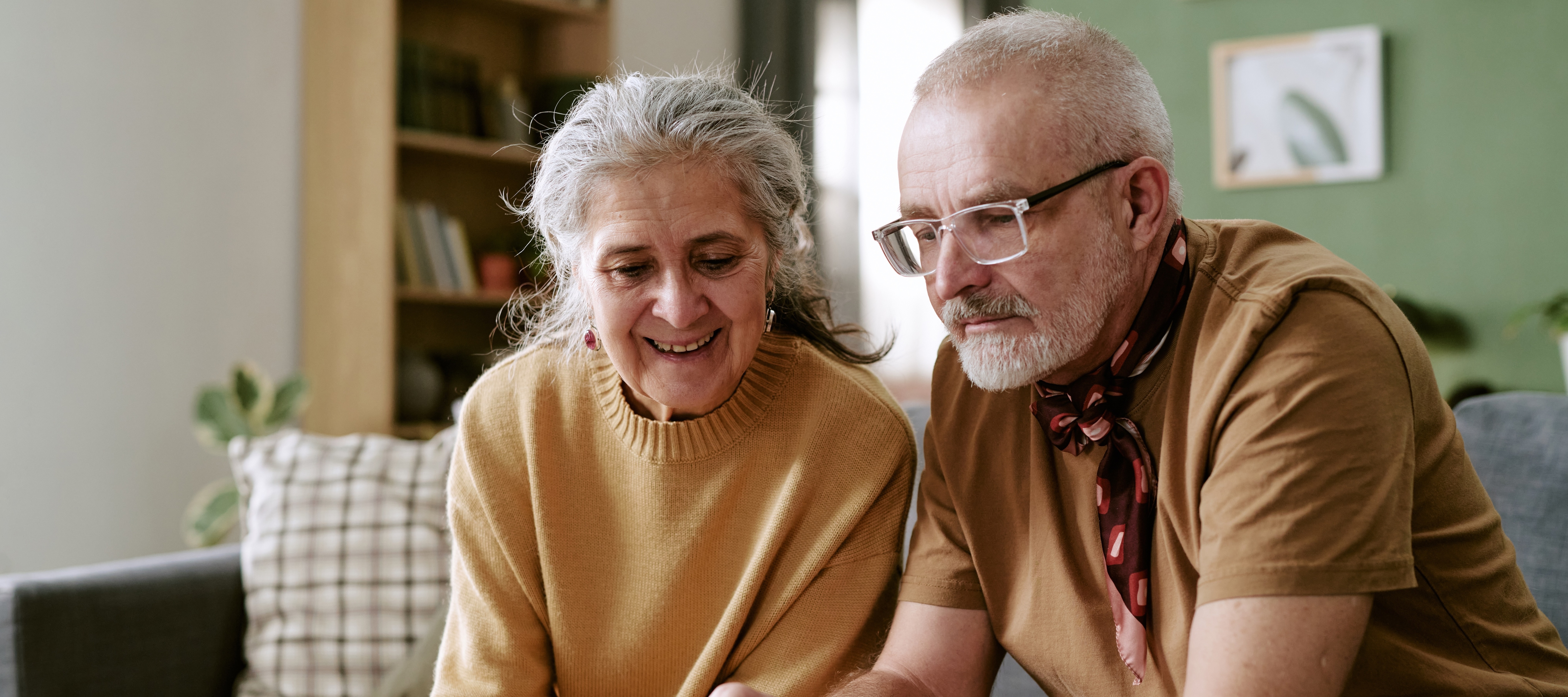 Older couple sitting and discussing their finances.