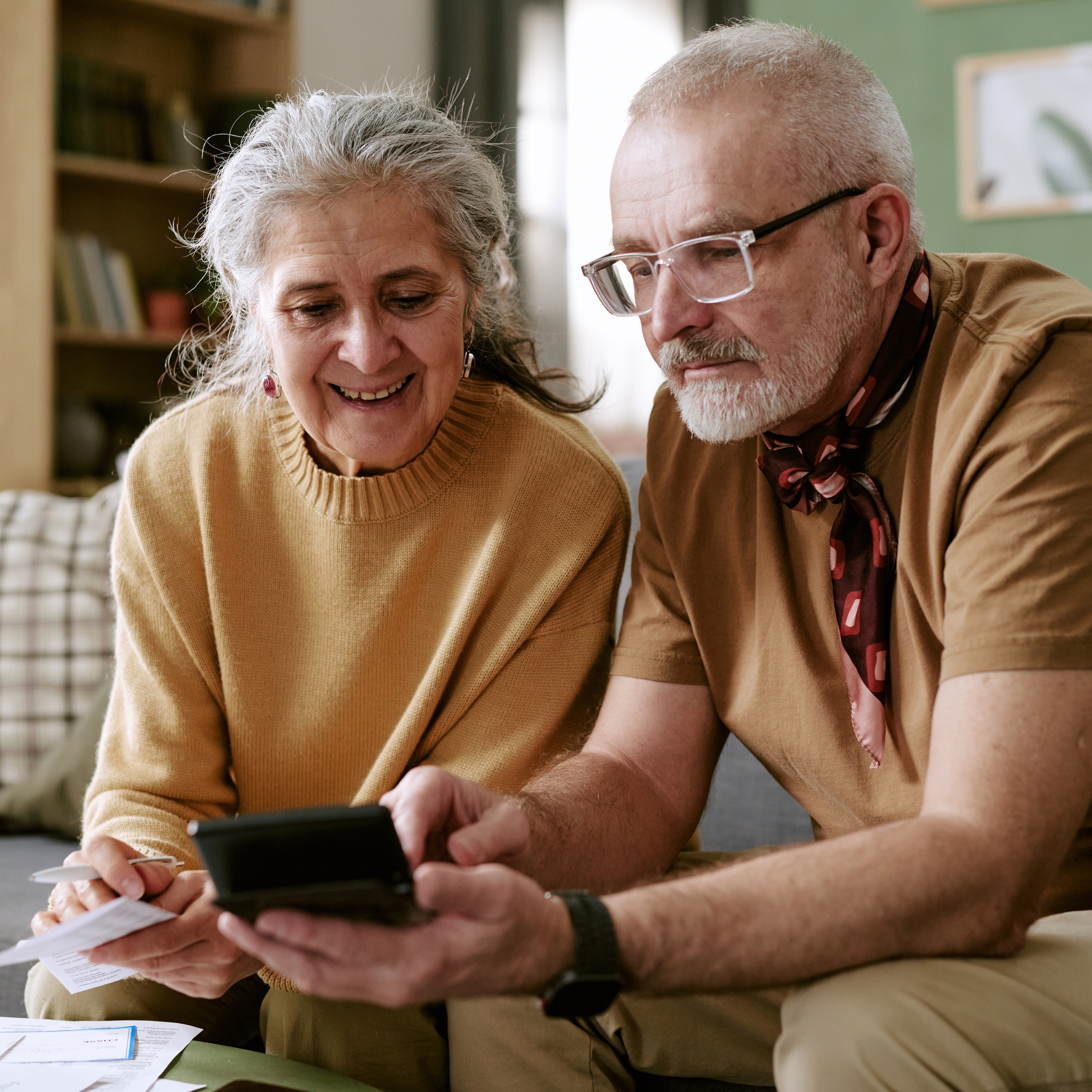 Older couple sitting and discussing their finances.