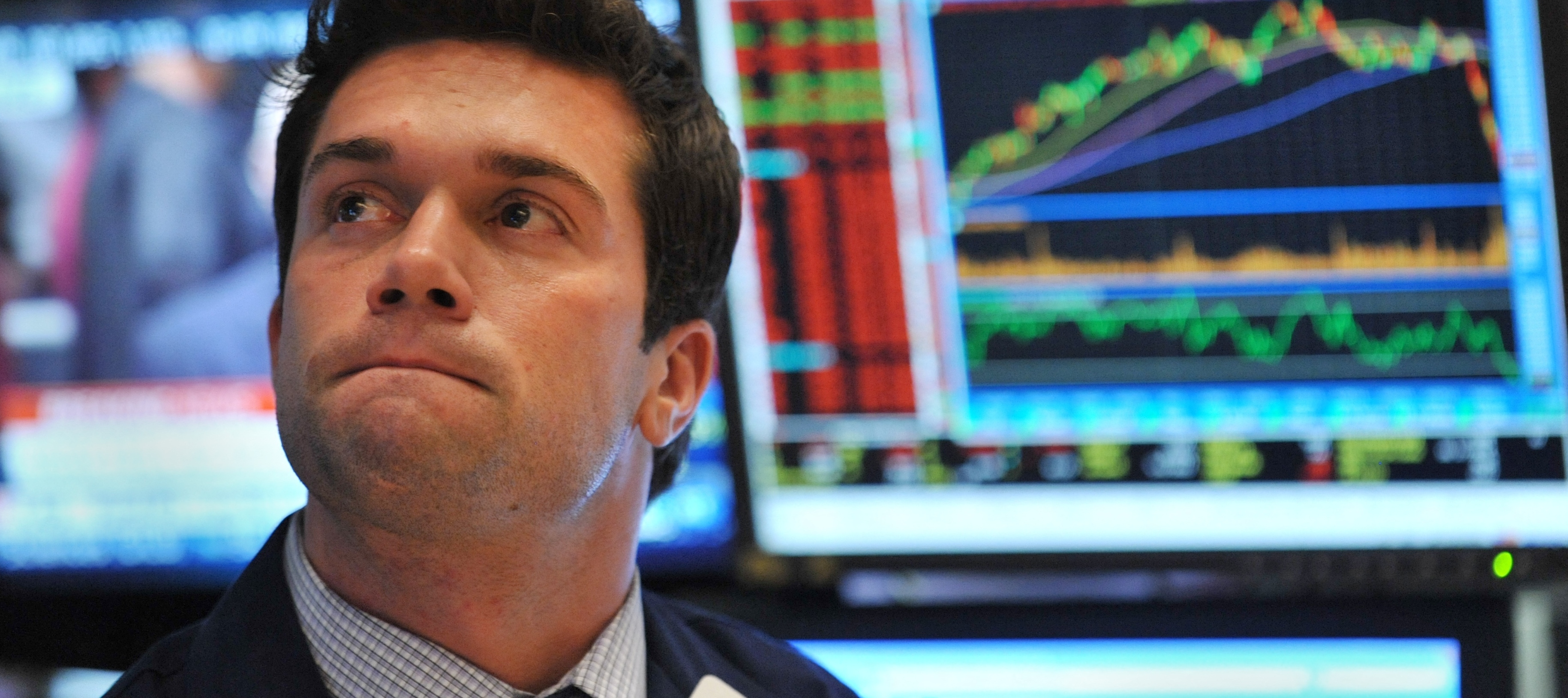 A trader watches prices on the New York Stock Exchange floor.
