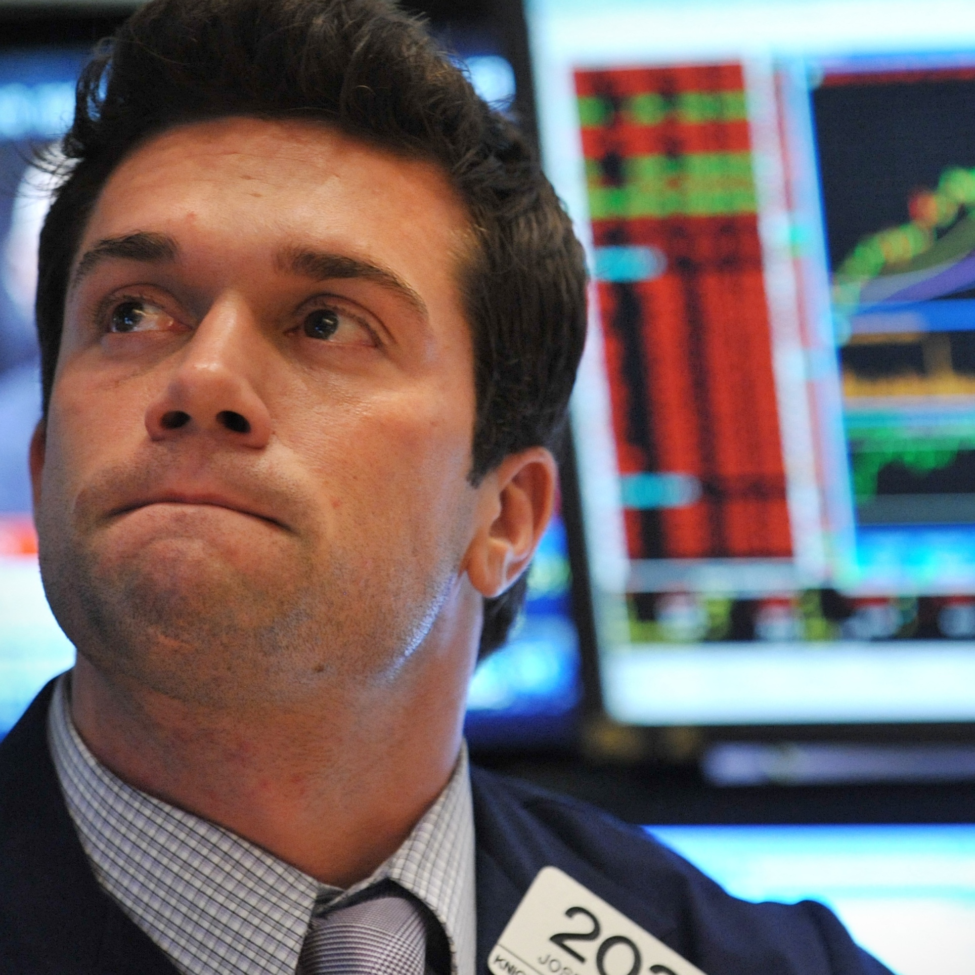 A trader watches prices on the New York Stock Exchange floor.