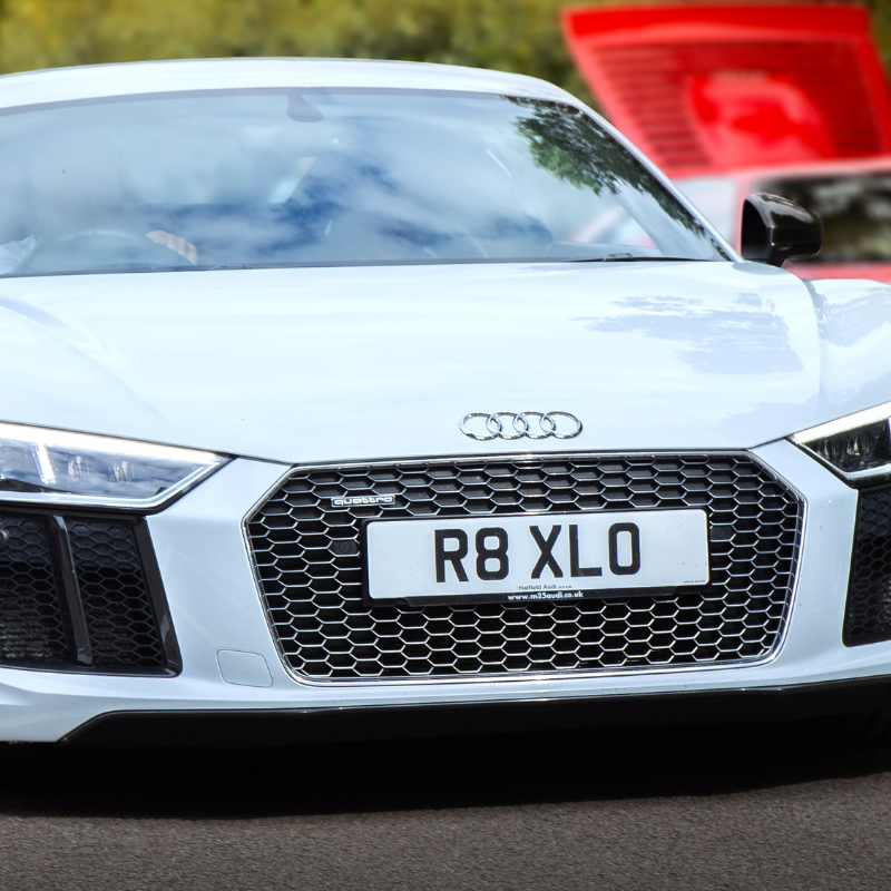 An image of the luxury Audi R8 alongside a bubble that contains an image of the back of a Pokémon card.