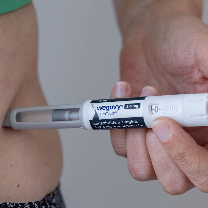 A photo of a person administering a Wegovy injection