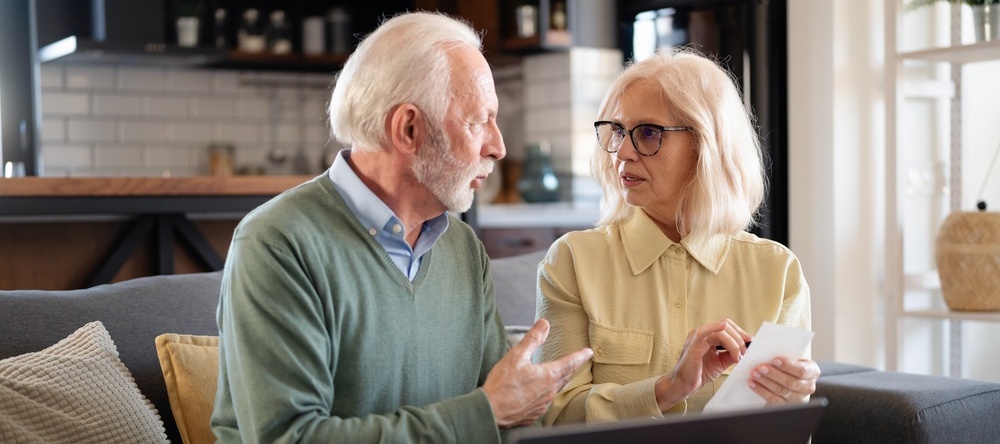 A photo of an older couple reviewing their finances together