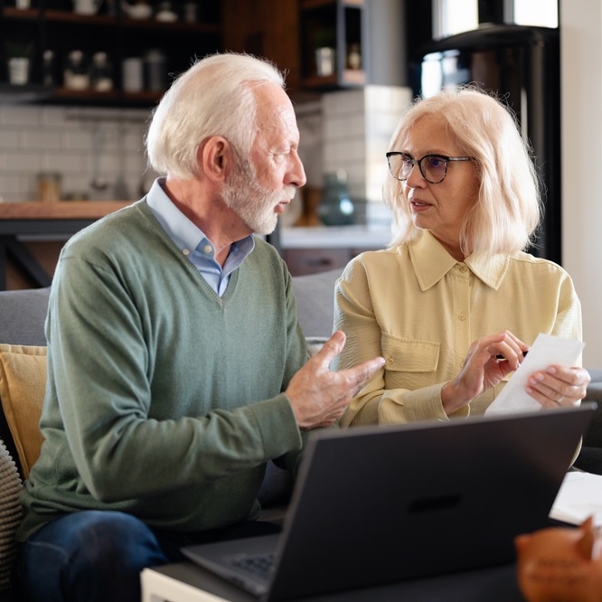 A photo of an older couple reviewing their finances together