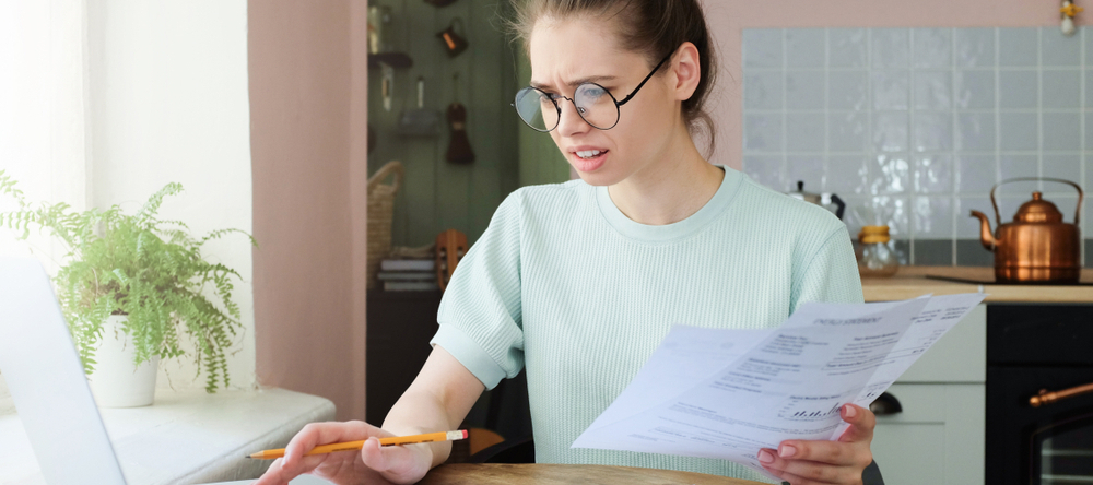 A photo of a female student reviewing her finances on her laptop