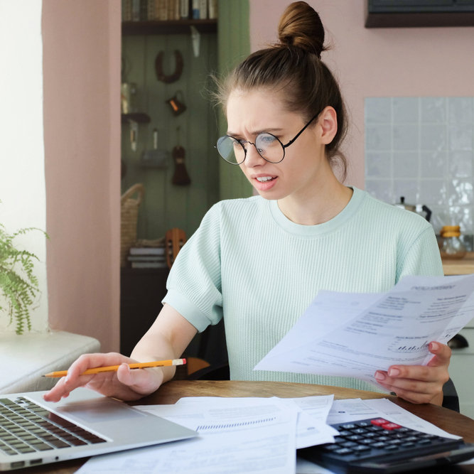 A photo of a female student reviewing her finances on her laptop