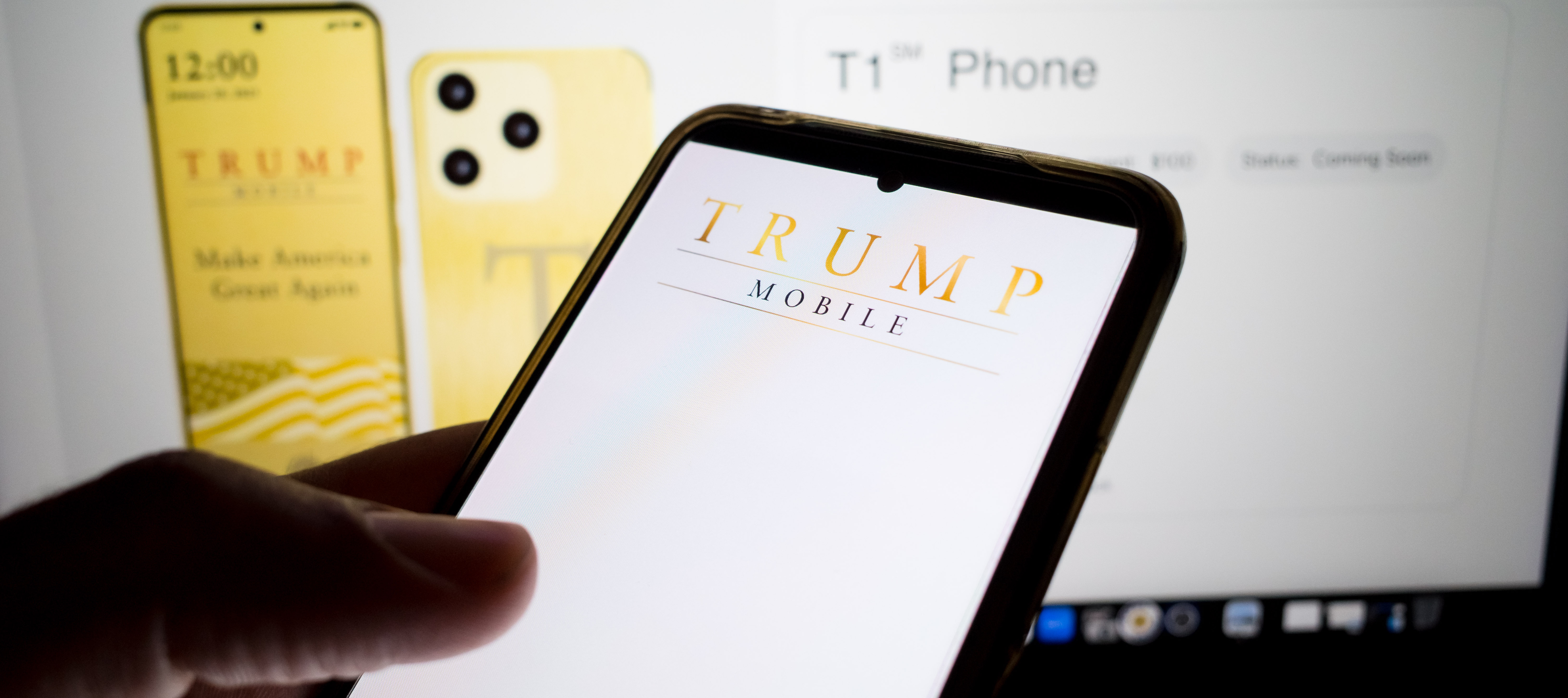 Person on Trump Mobile website on a smartphone with T1 phone preorder page up in the background.