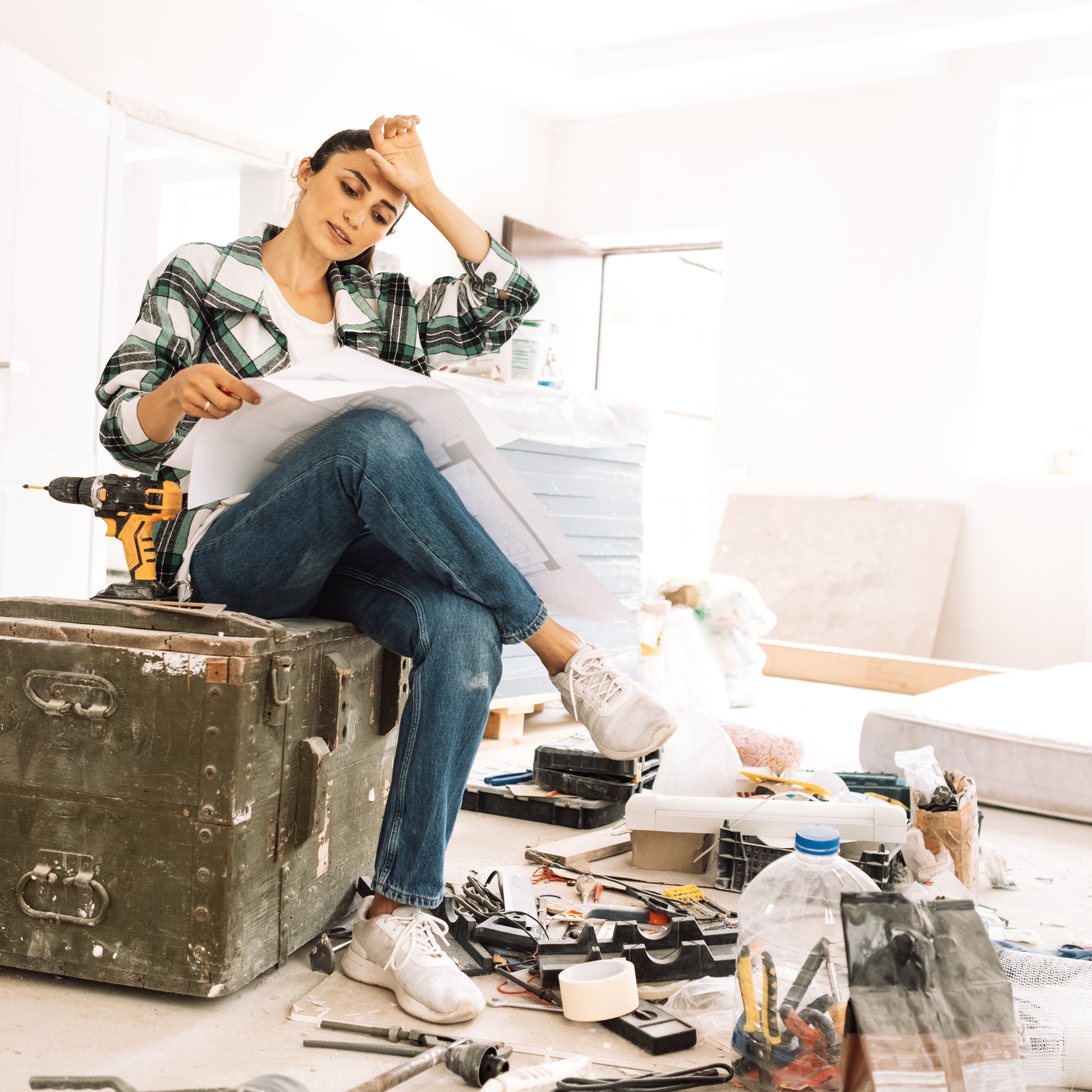 Young woman tired from house repairs