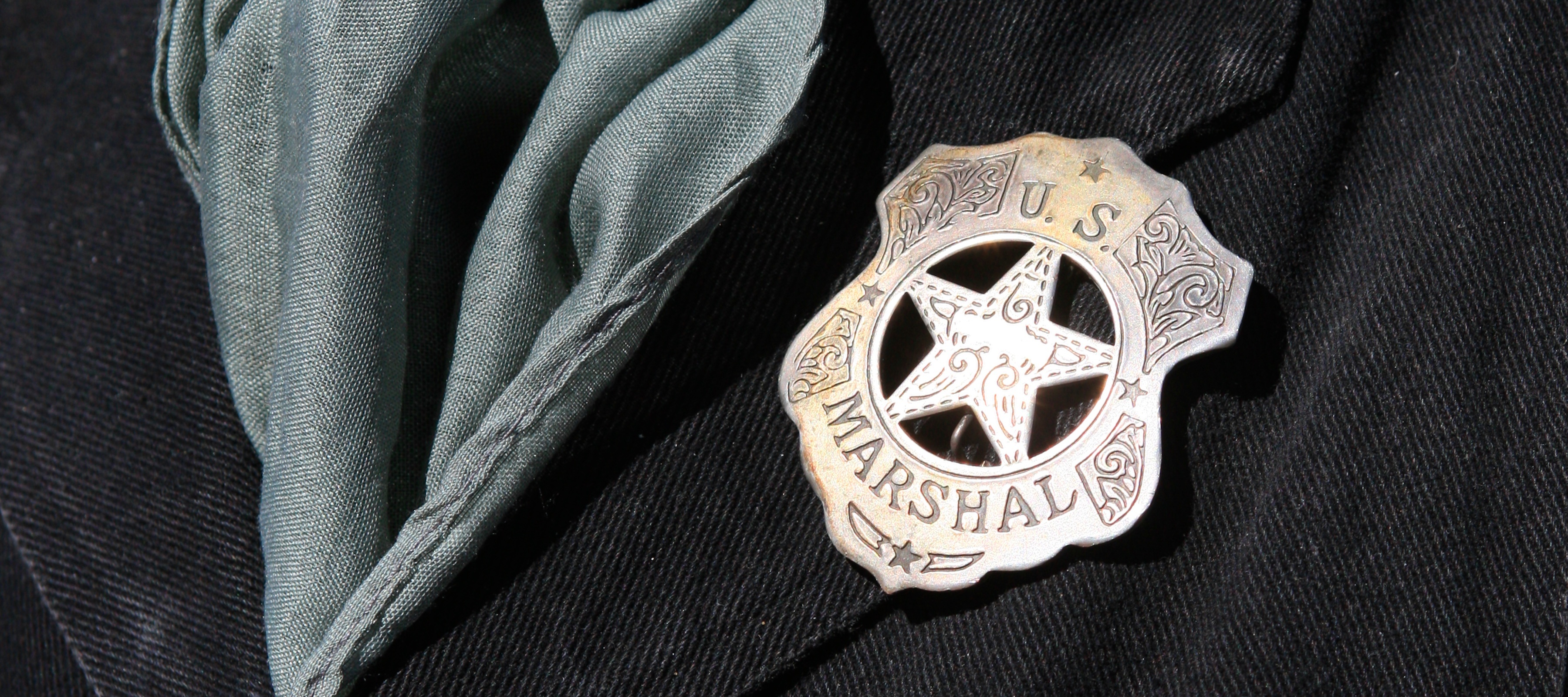 A close-up shot of a US marshal badget
