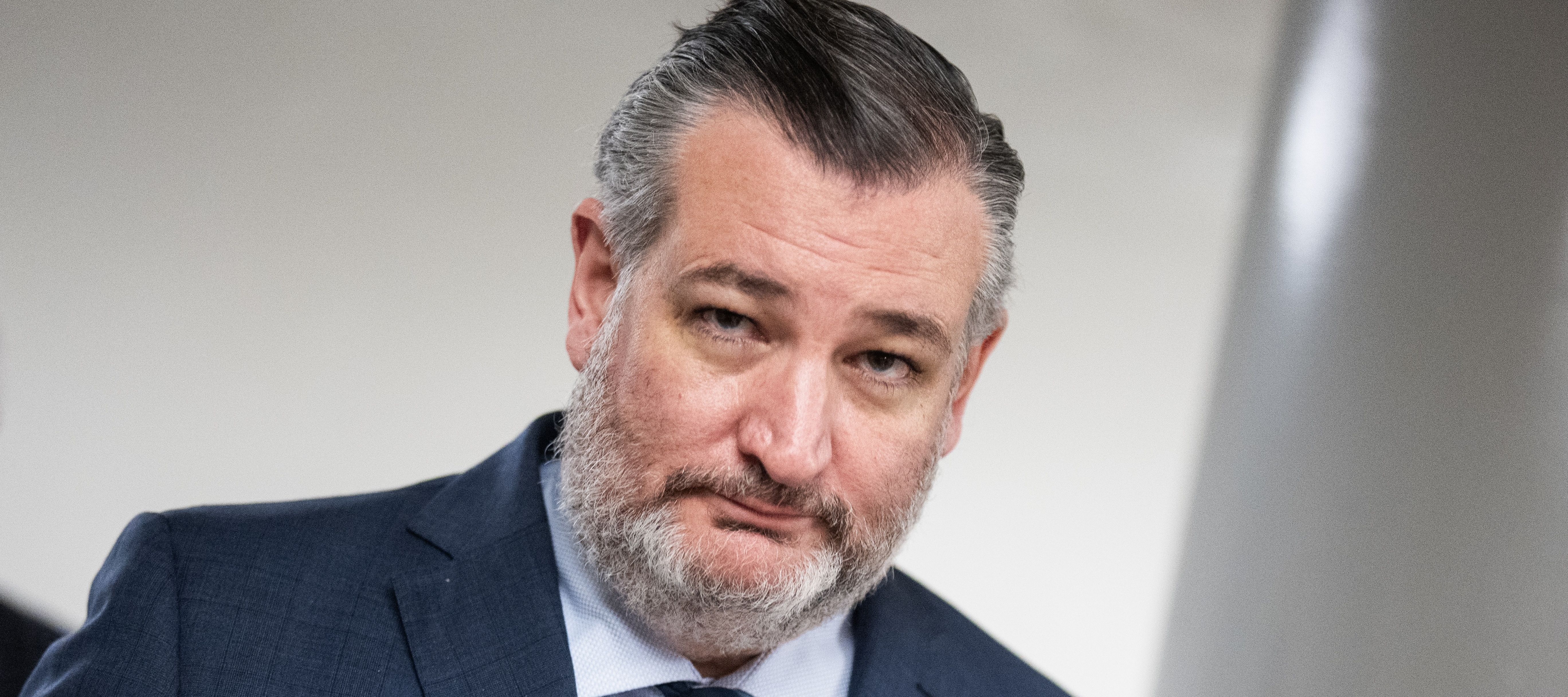 Ted Cruz looks at the camera in a dark blue suit and tie.