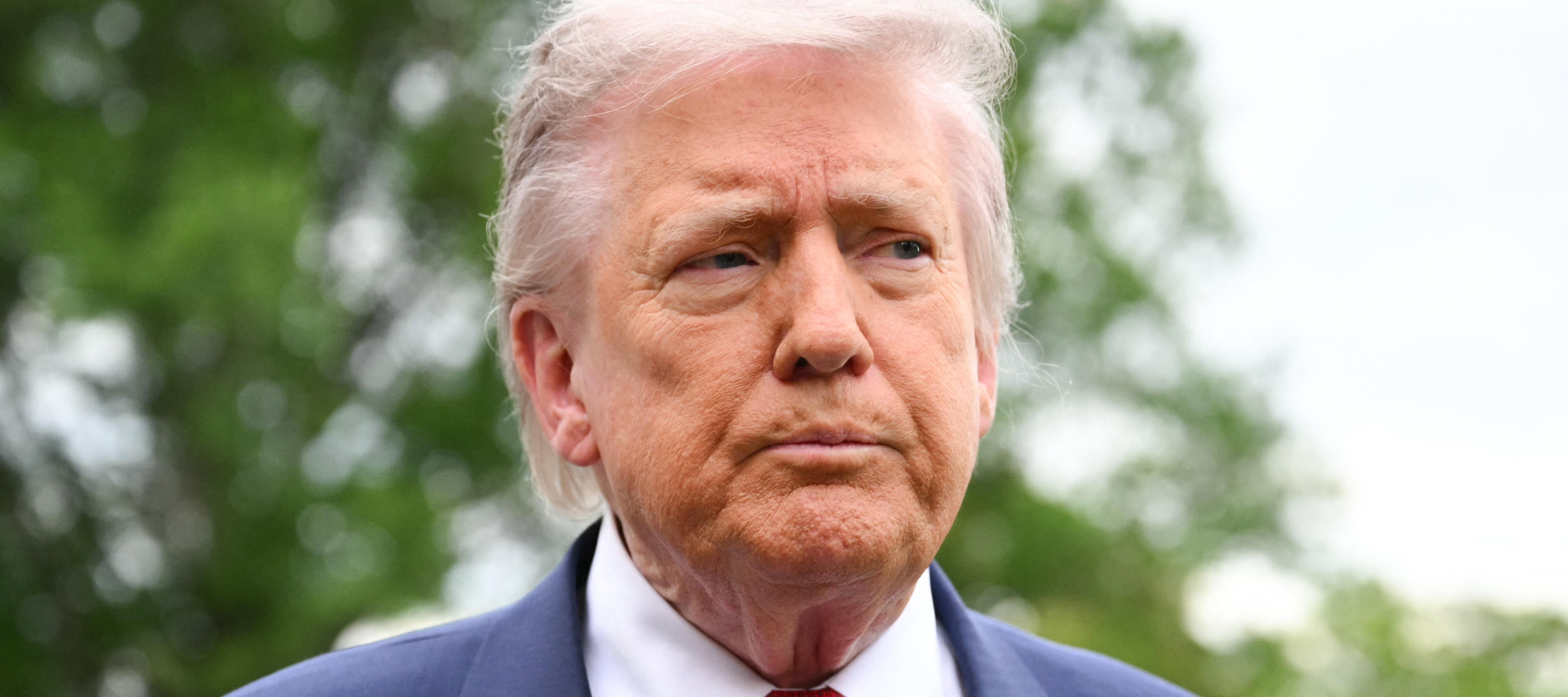 US President Donald Trump speaks to journalists as he makes his way to board Marine One before departing from the South Lawn of the White House in Washington, DC.