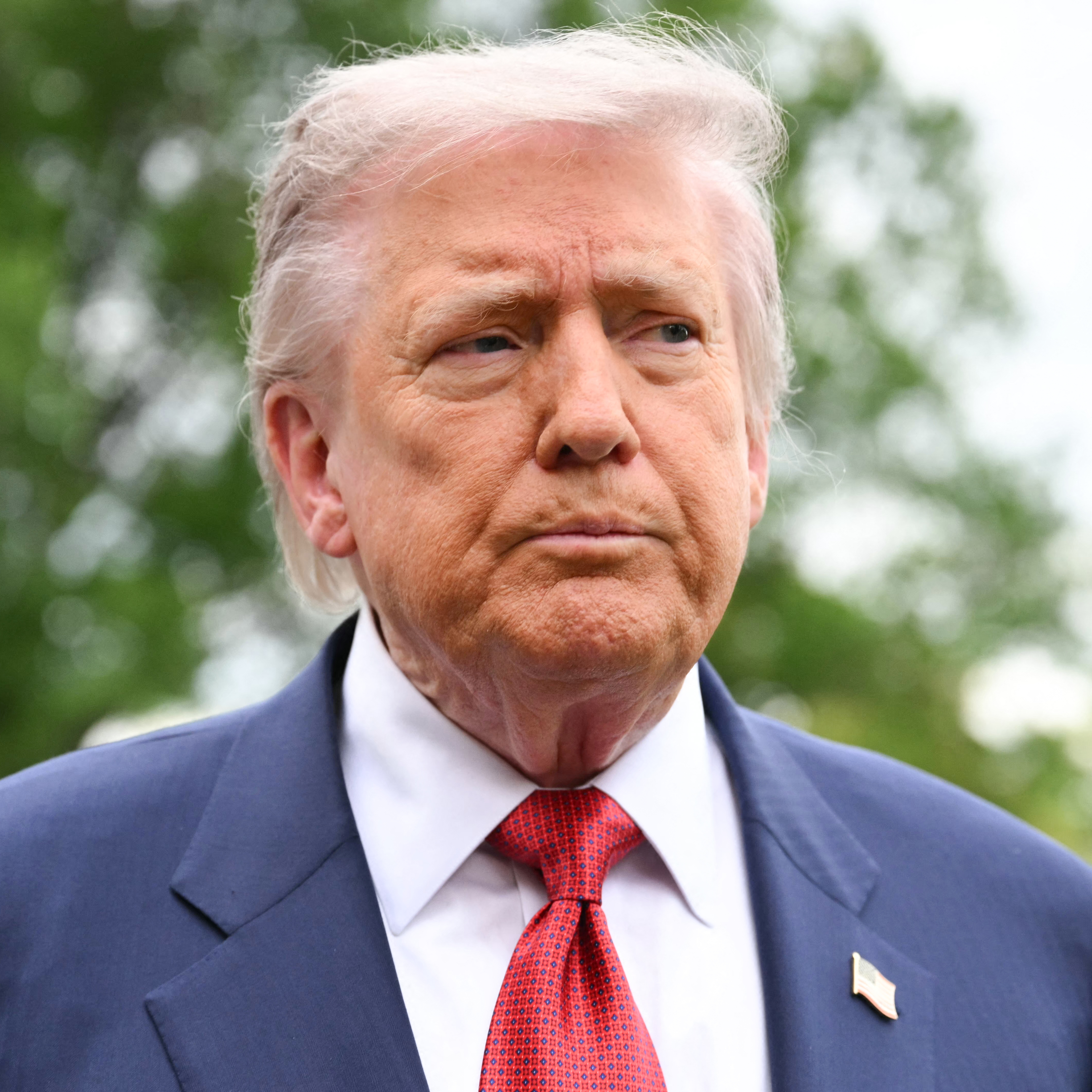 US President Donald Trump speaks to journalists as he makes his way to board Marine One before departing from the South Lawn of the White House in Washington, DC.