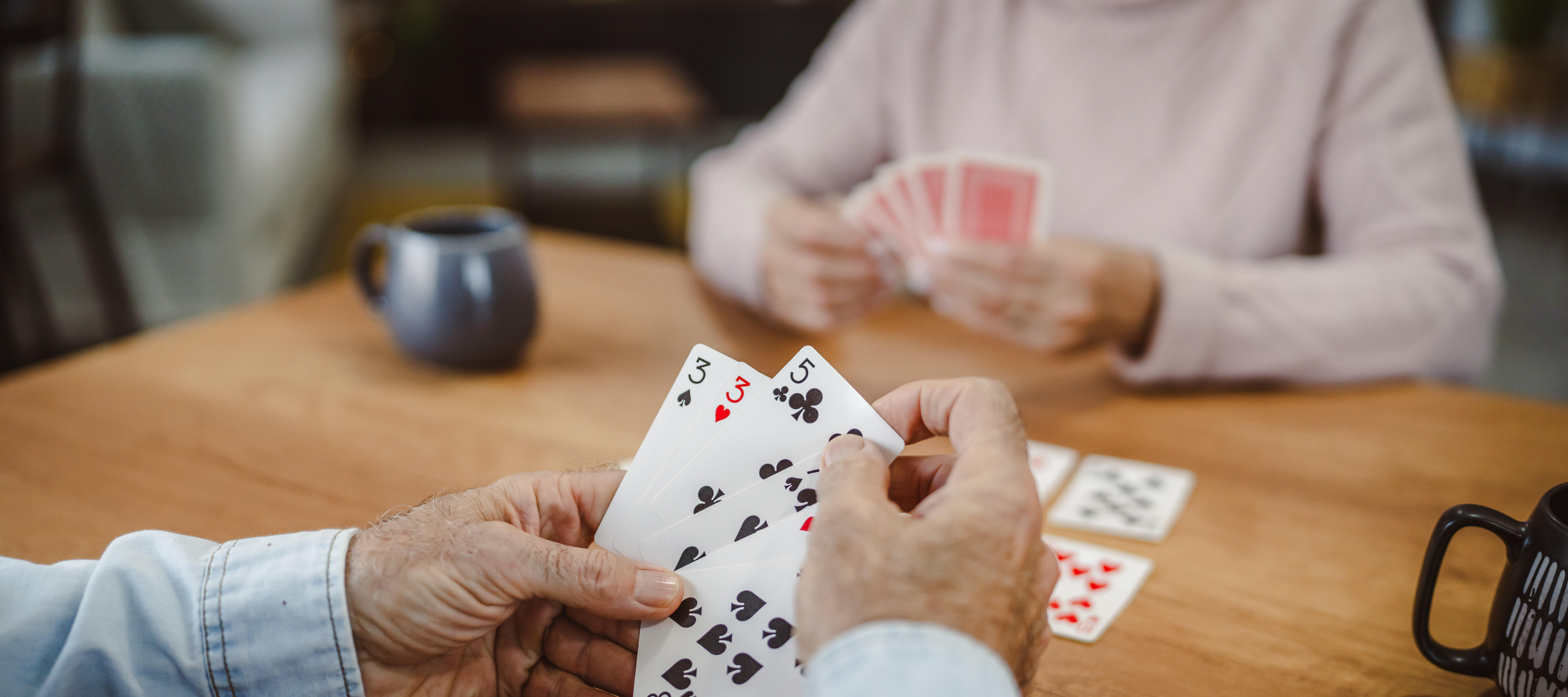 An older couple enjoying a game of cards.
