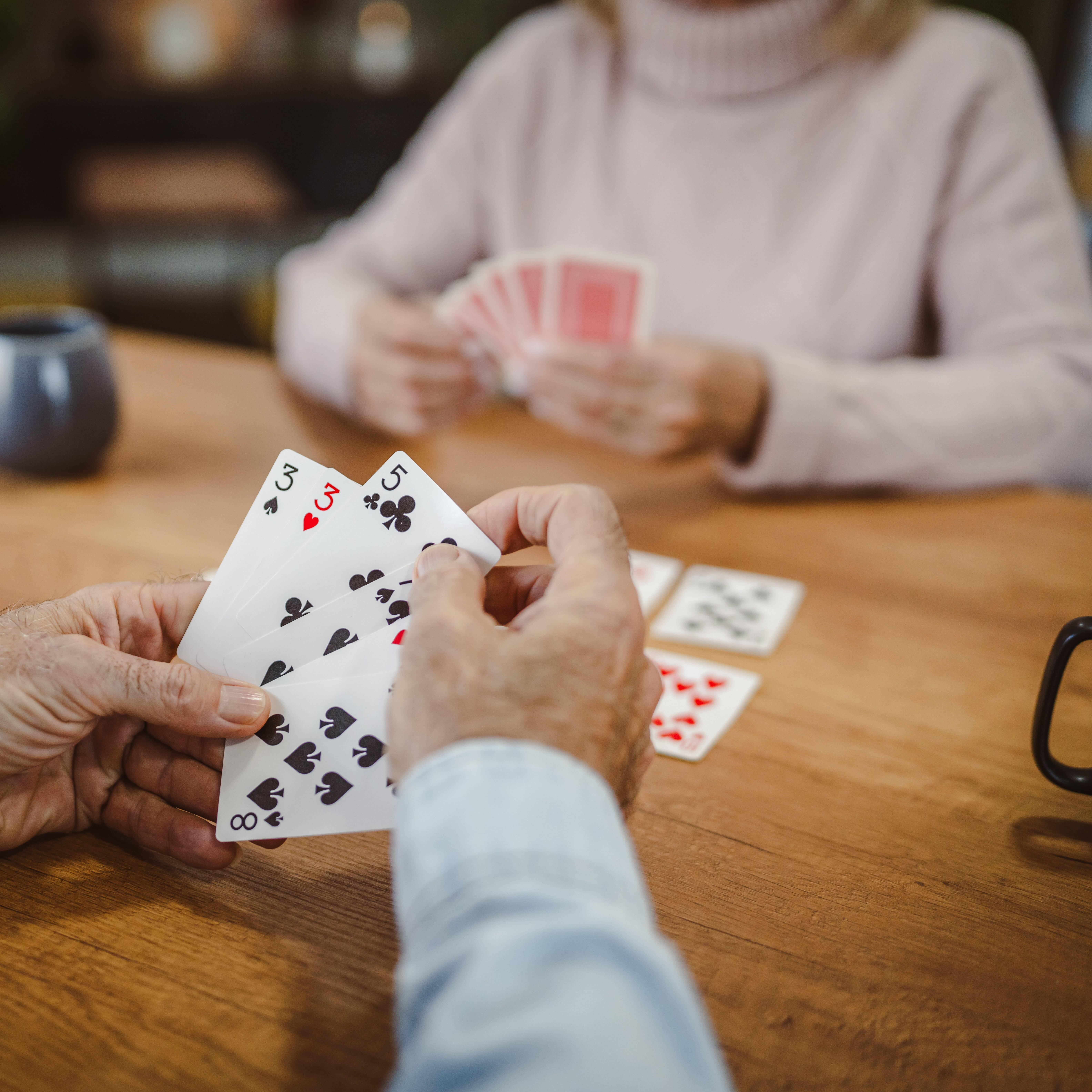 An older couple enjoying a game of cards.