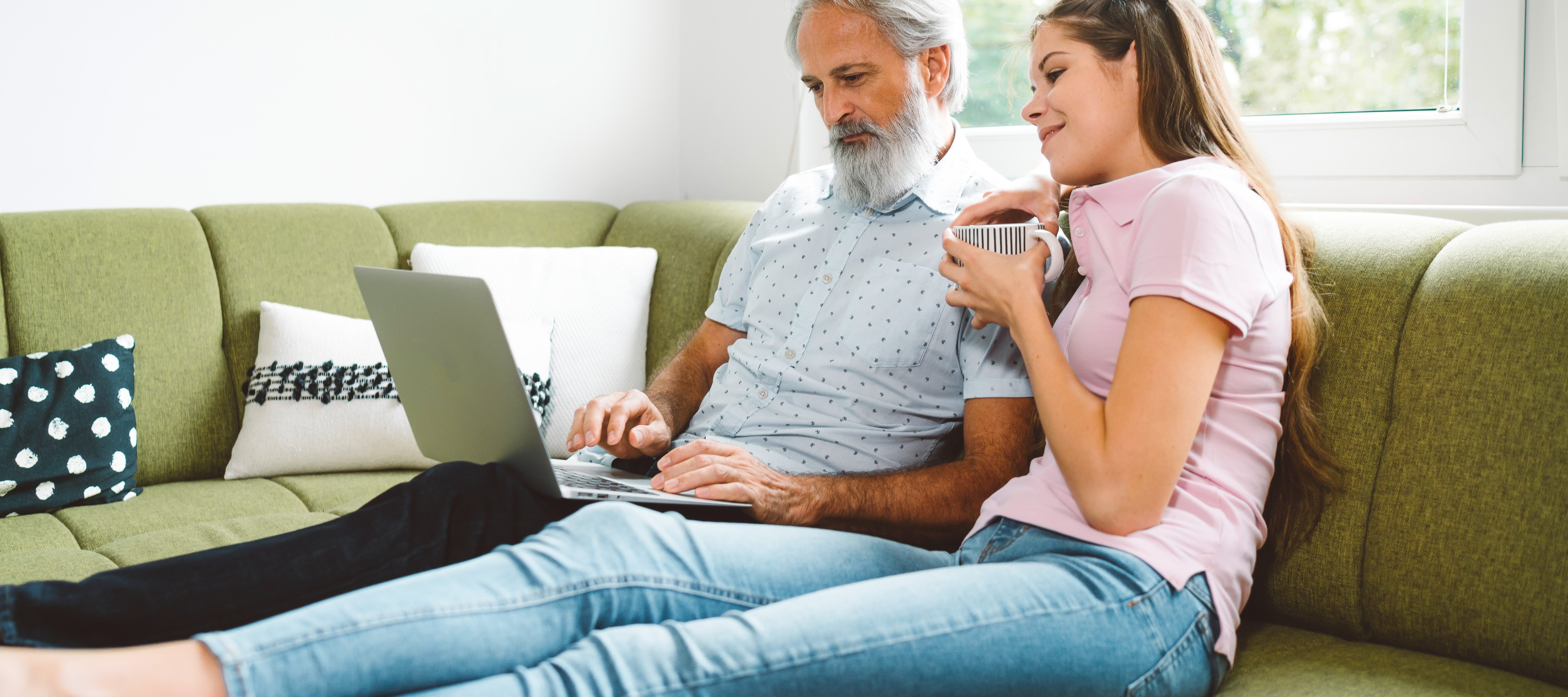 Senior man talking with his daughter on the couch