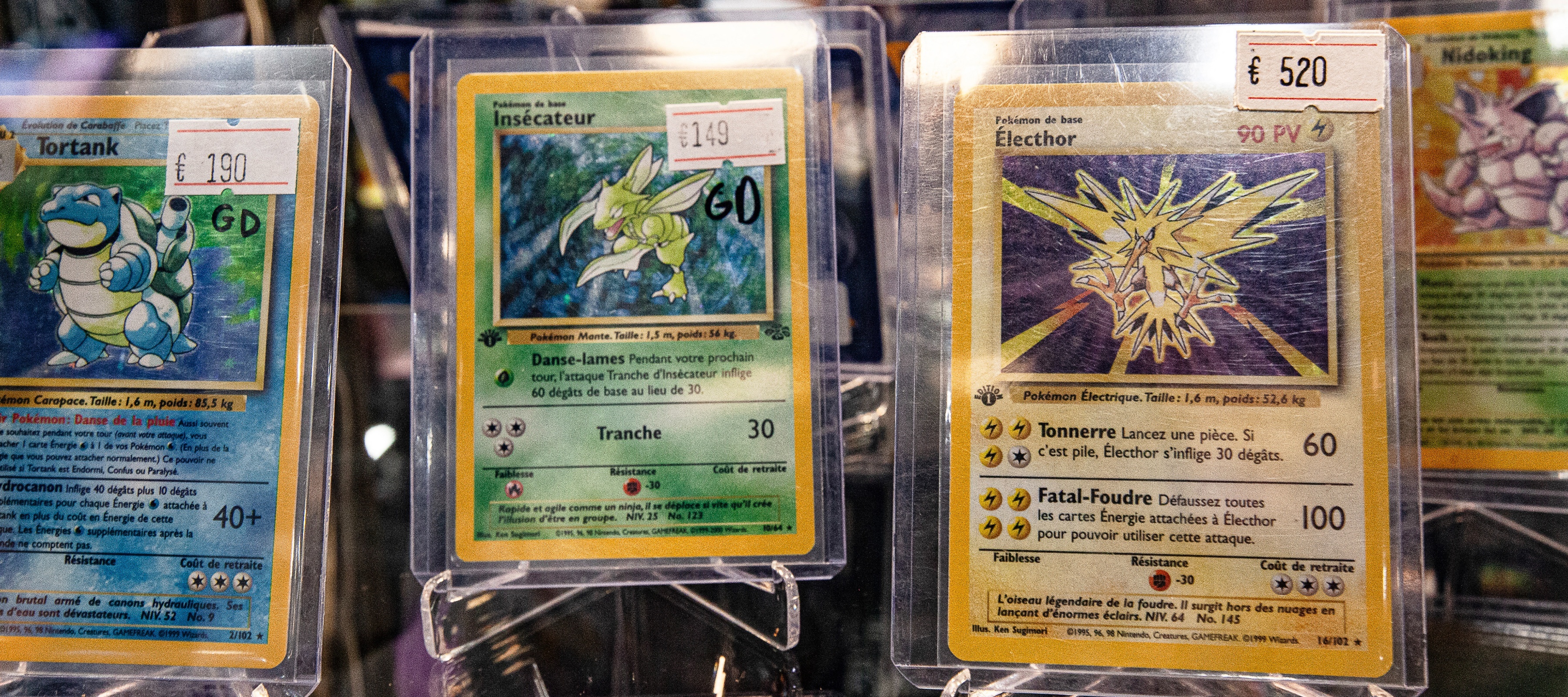 Pokemon cards on display with their sale value next to them