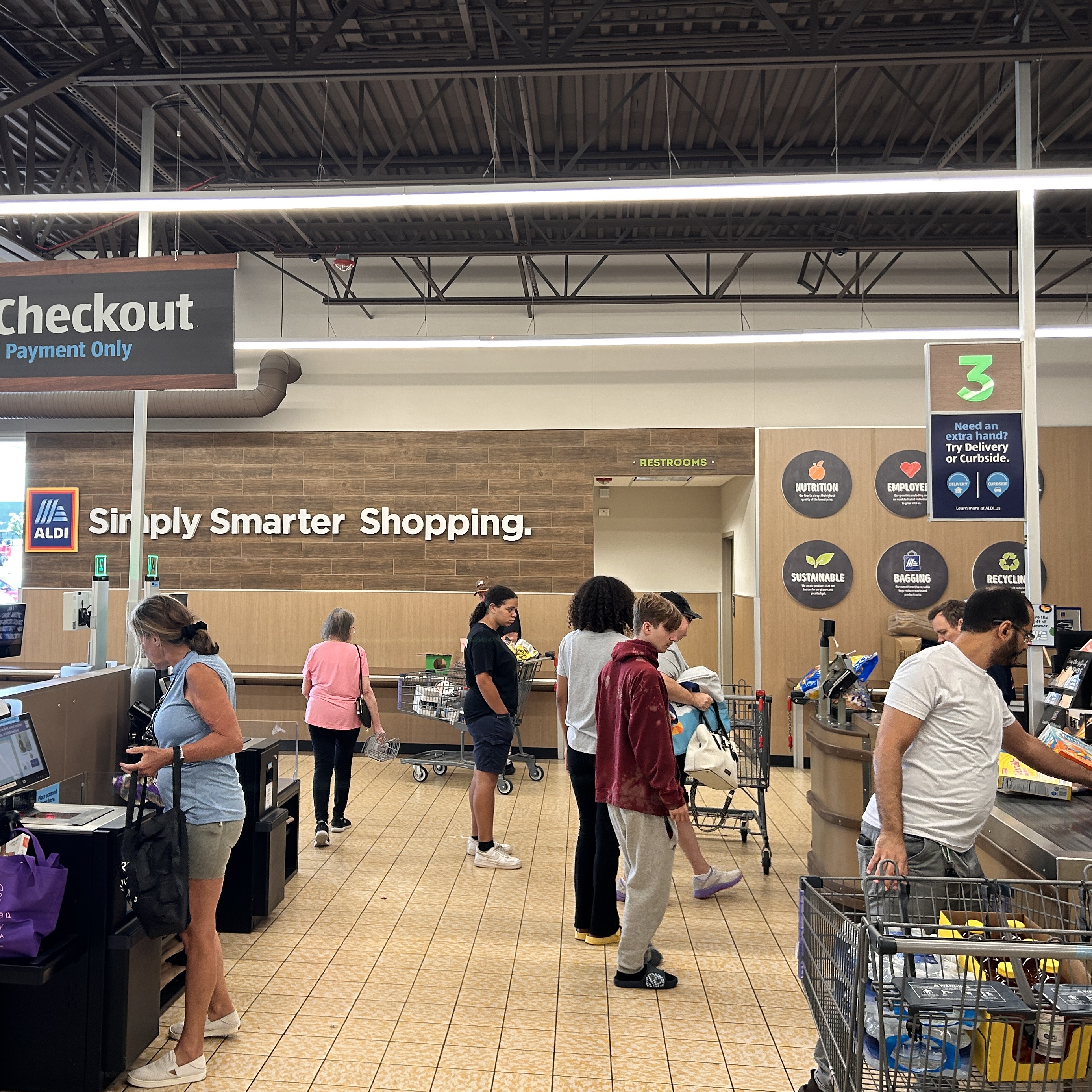 Customers use self-checkout machines at an Aldi store in Charlotte, North Carolina.