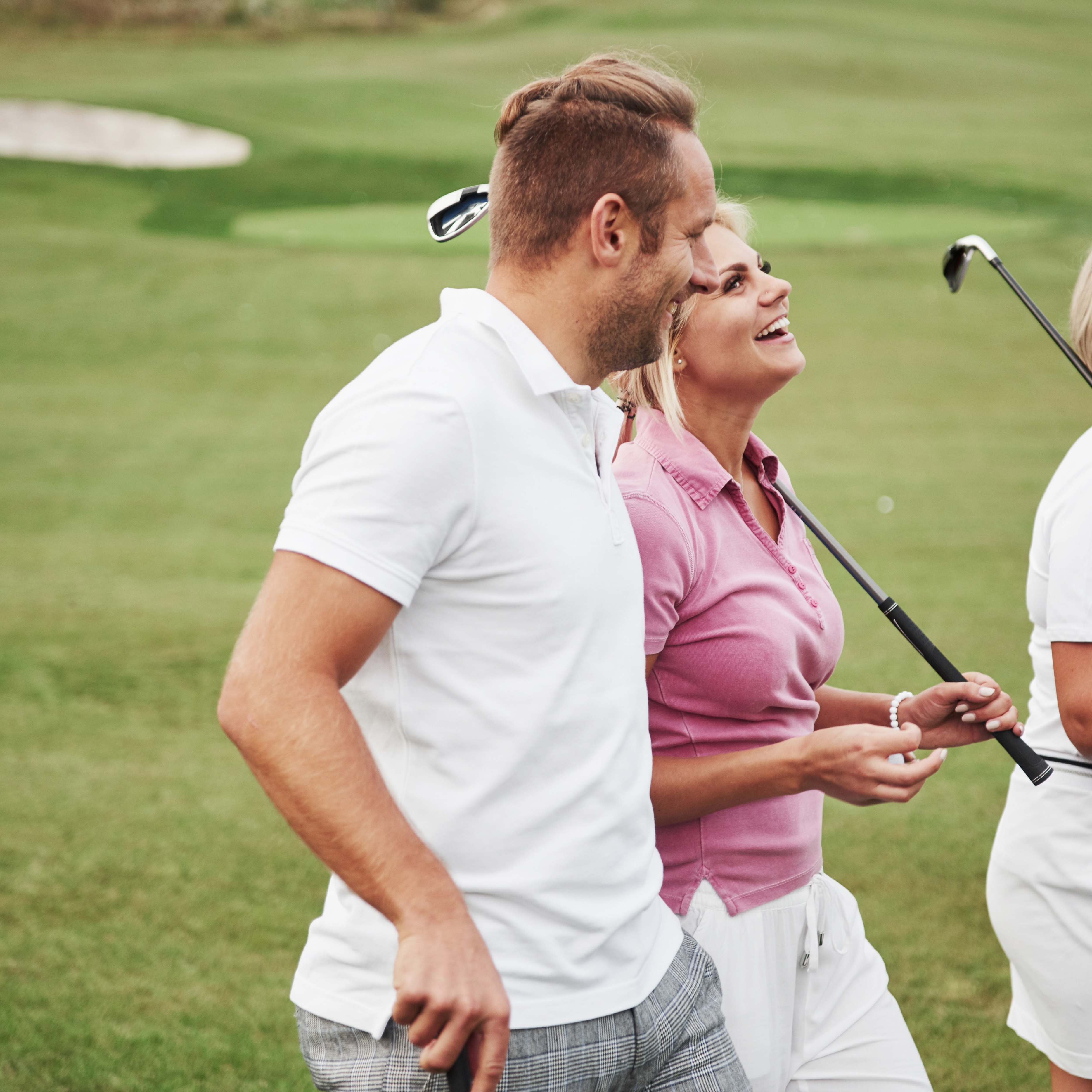 Two young couple on a golf course