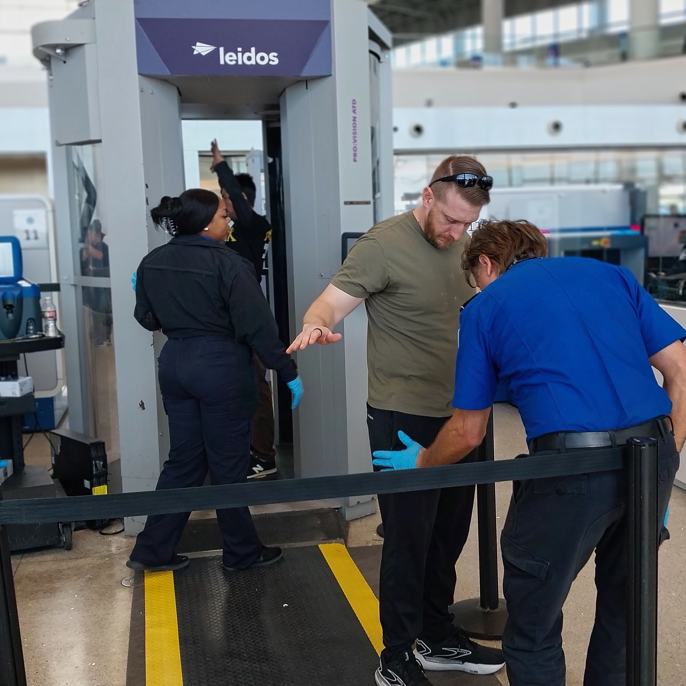 A departing passenger receives a routine pat down in New Orleans.