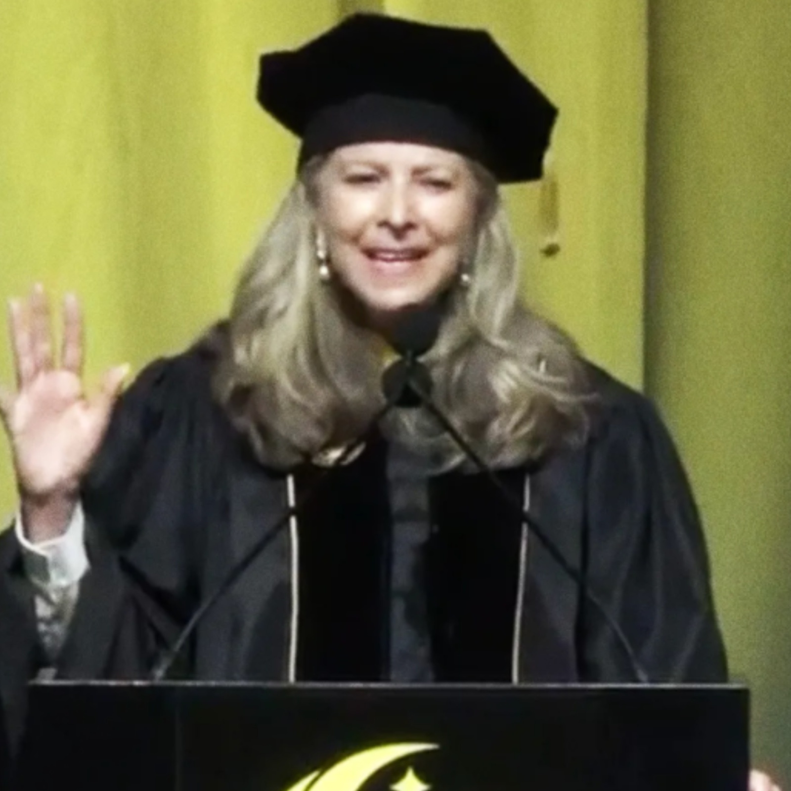 A photo of Gloria Caulfield from Tavistock Development Company giving the commencement speech at U of Central Florida