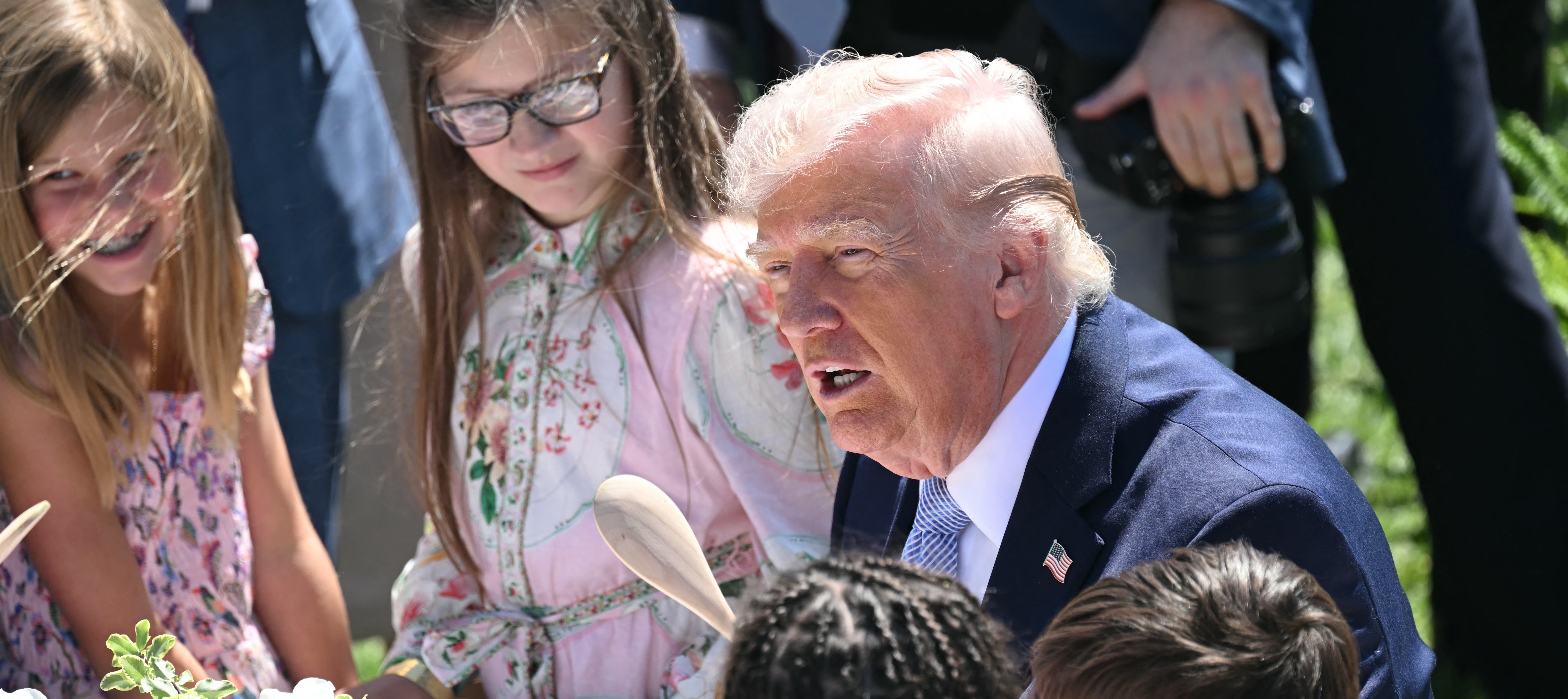President Donald Trump participates in a coloring activity with children at the South Lawn at the White House.