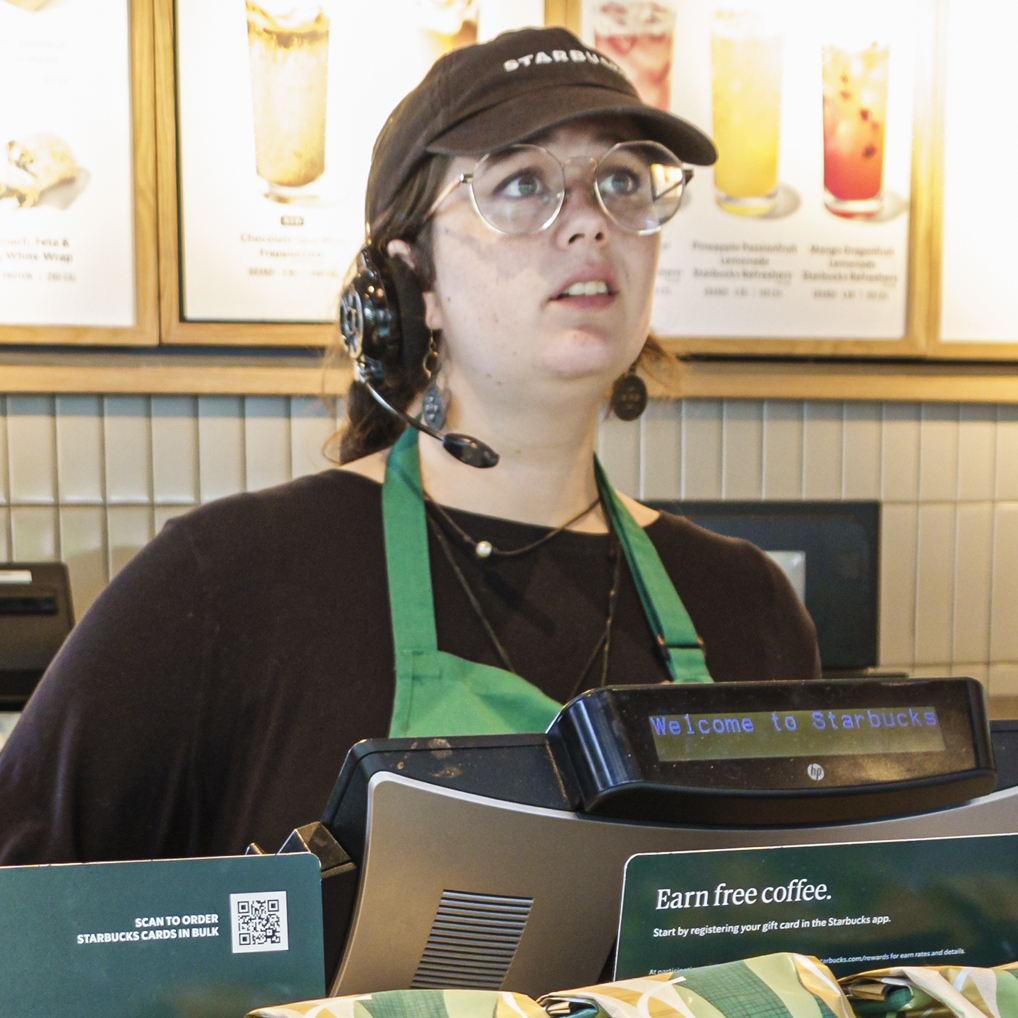 A Starbucks barista with a headset at a cashier in Augusta, Georgia.