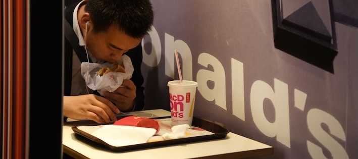 A man eats in a McDonald's restaurant