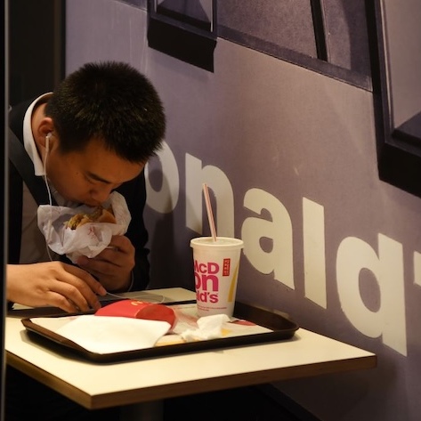 A man eats in a McDonald's restaurant