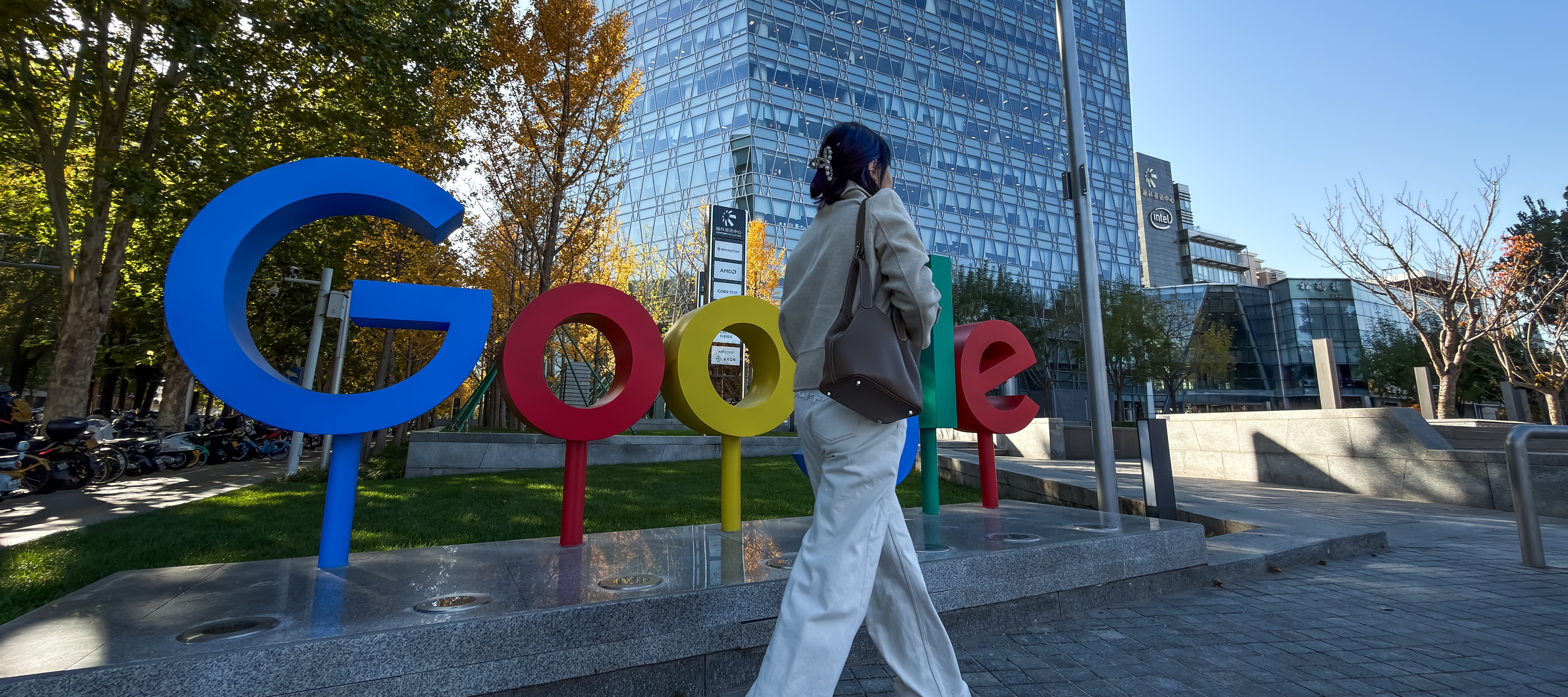 A pedestrian walks past the Google logo outside a commercial building that houses the company's Beijing office.