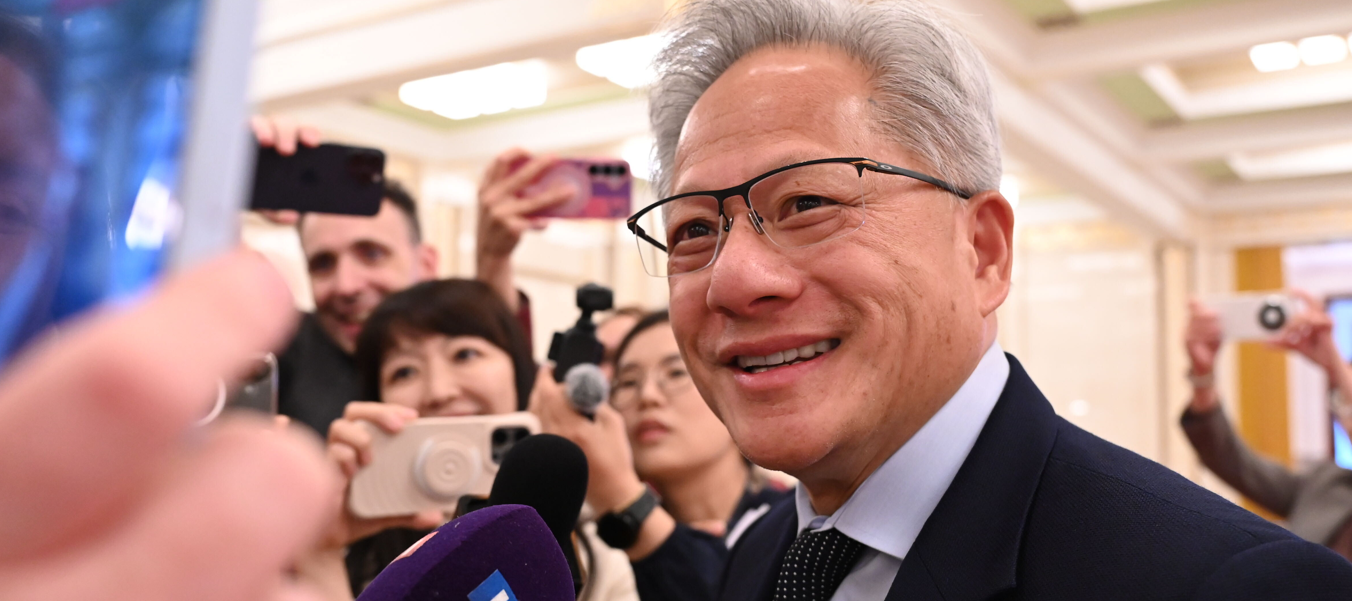 Jensen Huang, seen here accompanying President Trump on his visit to China, recently told Carnegie Mellon grads that jobs in the trades are in demand.