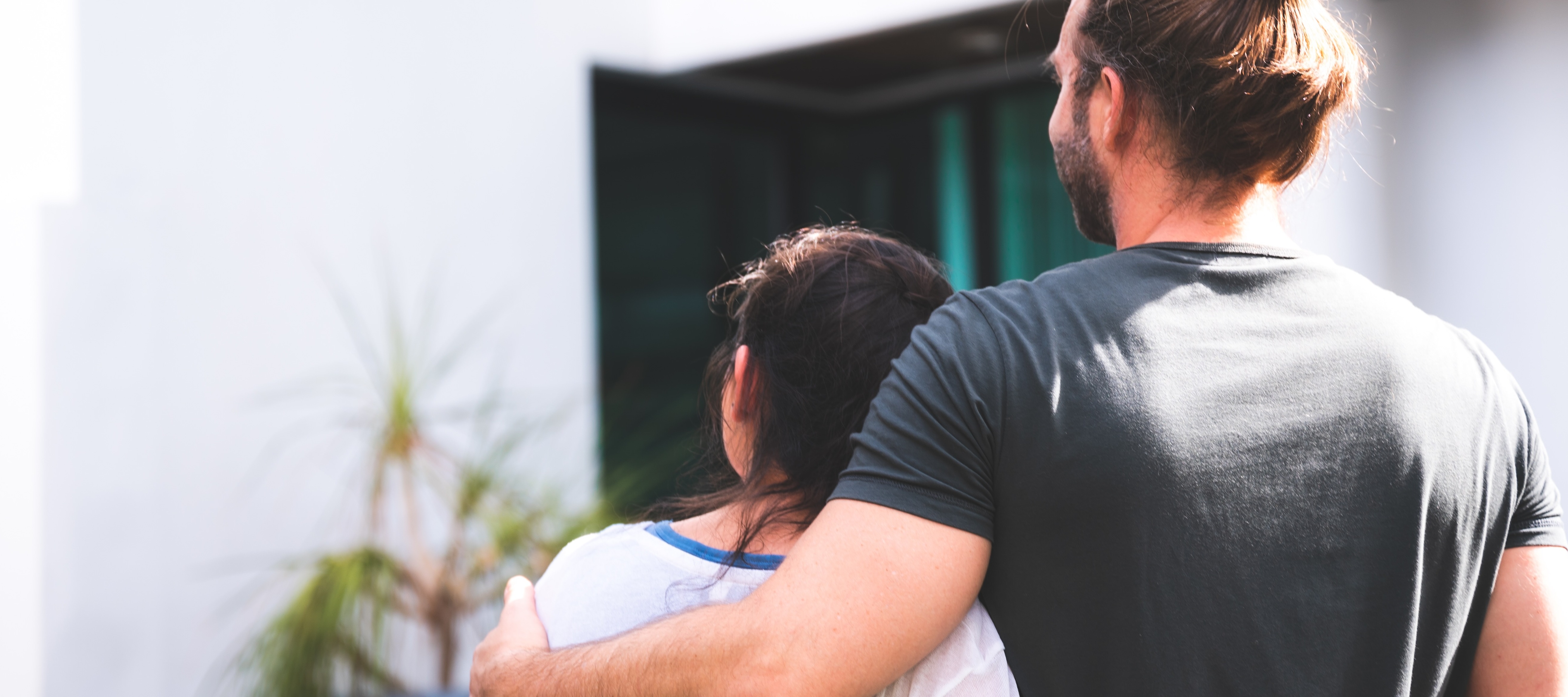 Younger couple looking towards house