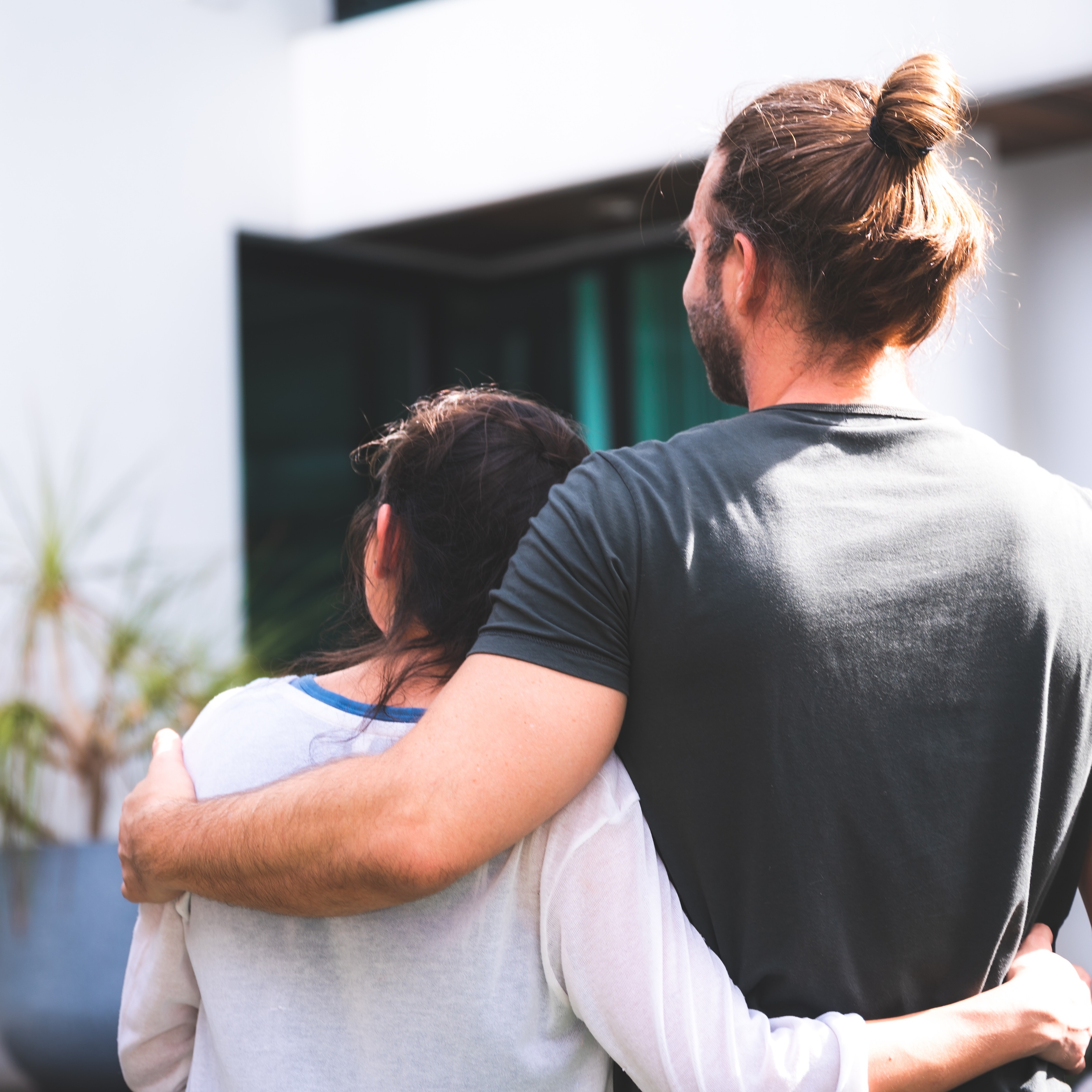 Younger couple looking towards house