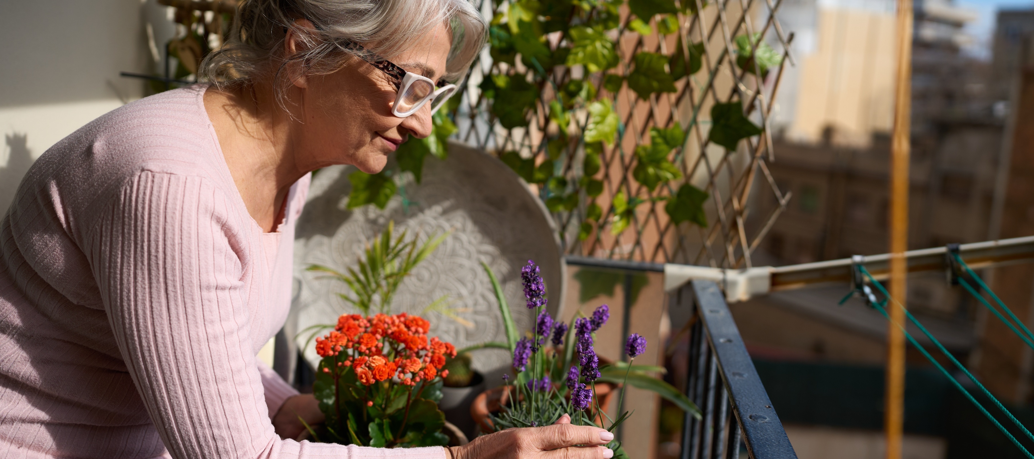 A retired woman tends to flowers on her balcony and is missing her backyard garden from when she owned a home.