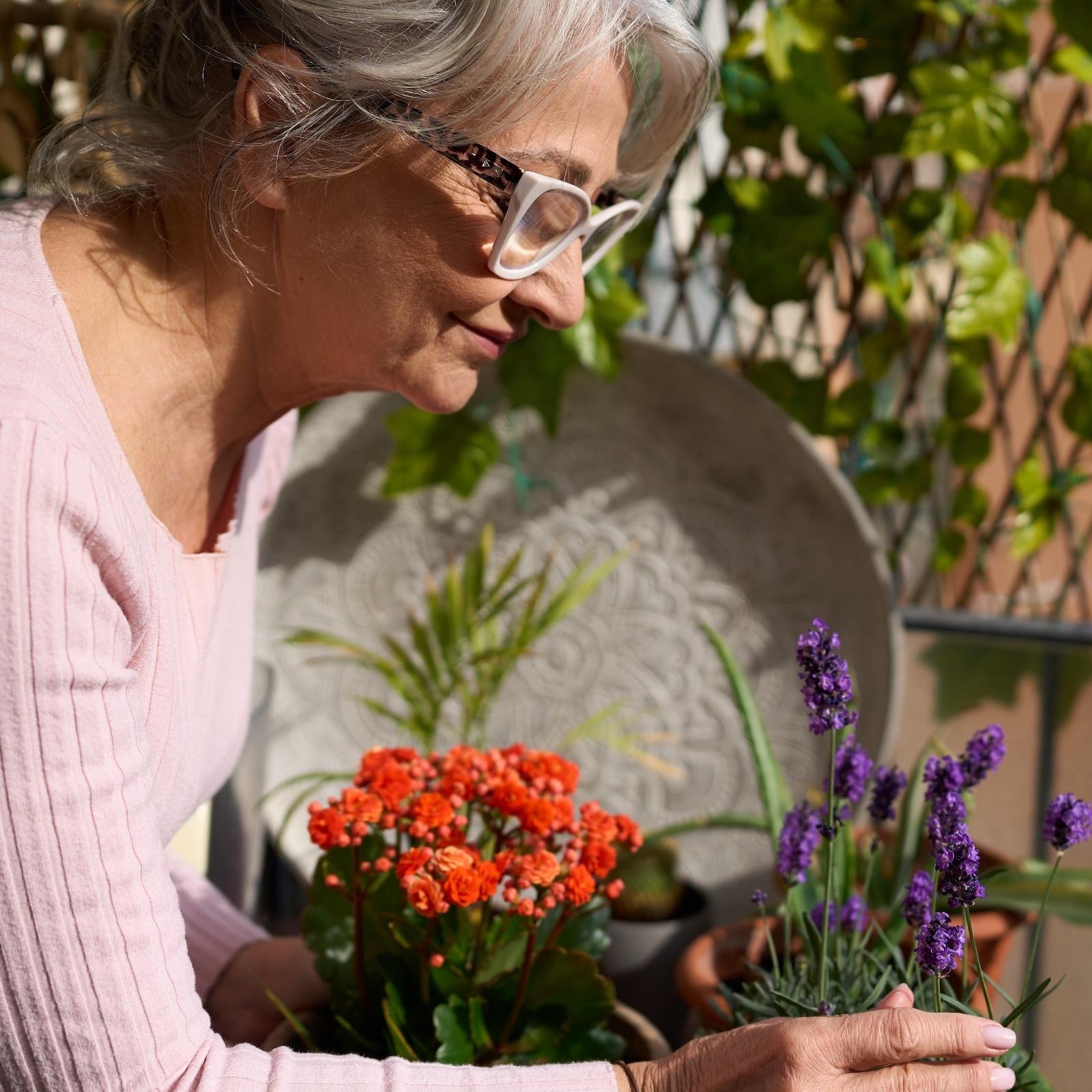 A retired woman tends to flowers on her balcony and is missing her backyard garden from when she owned a home.