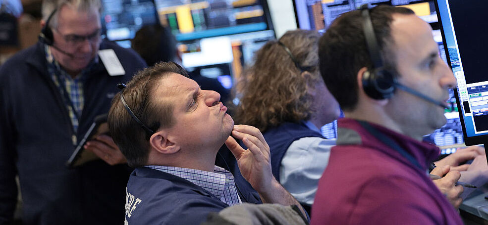 Traders work on the floor of the New York Stock Exchange during morning trading.