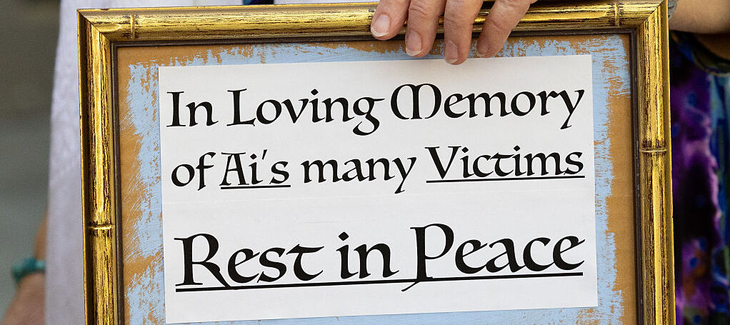 A photo of a framed note that reads "in loving memory of AI's many victims, rest in peace"