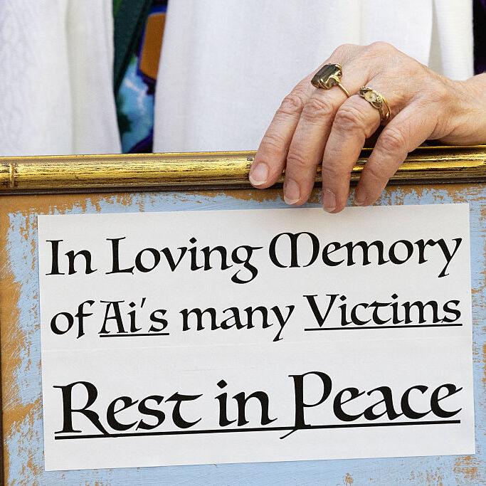 A photo of a framed note that reads "in loving memory of AI's many victims, rest in peace"