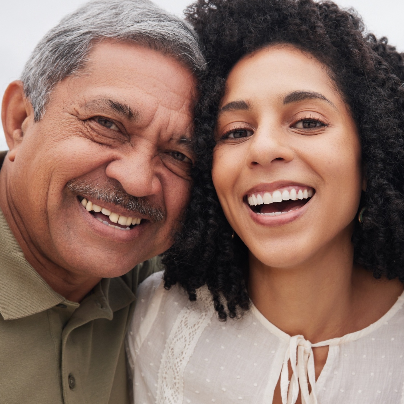 A retired couple smiles on the beach with their daughter but their wealth may one day be transferred to long-term care costs instead of family
