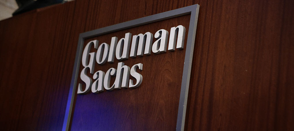 he Goldman Sachs company logo is displayed in their work area on the floor of the New York Stock Exchange.
