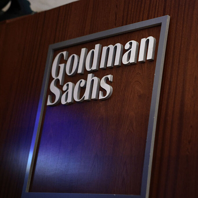 he Goldman Sachs company logo is displayed in their work area on the floor of the New York Stock Exchange.