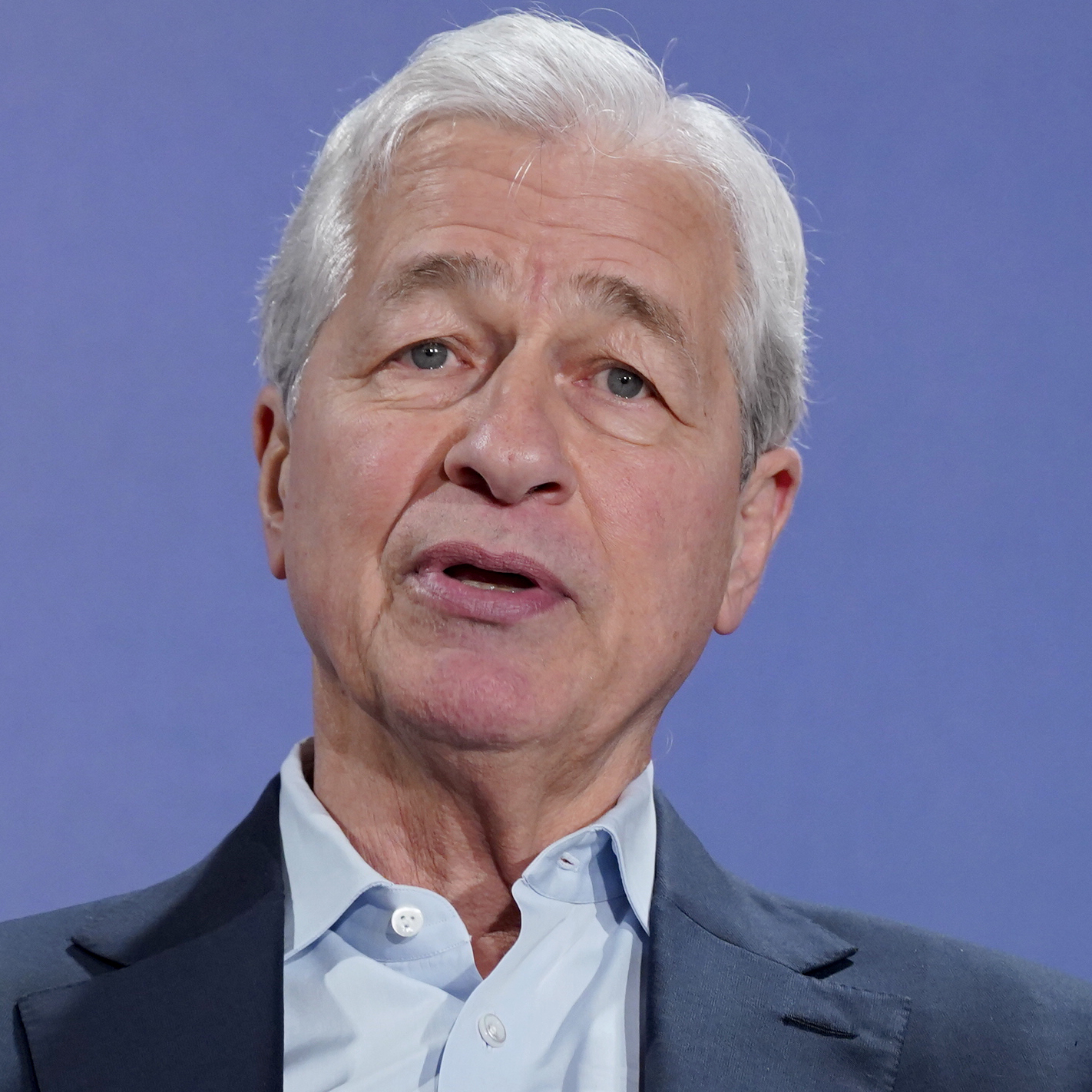 Jamie Dimon is taking a cautious market stance amid geopolitical risks, inflation, and an overhyped AI bubble.