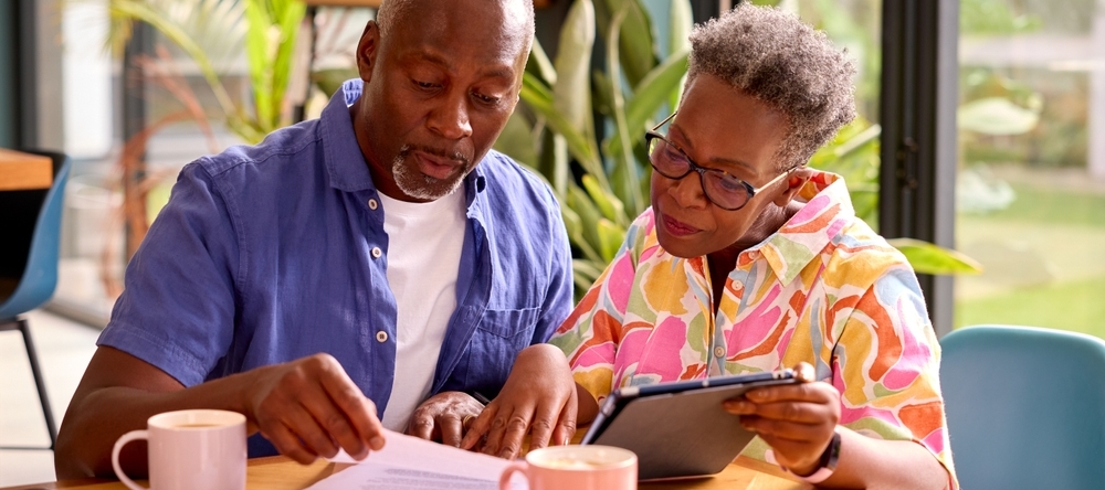 A photo of an older couple reviewing their finances