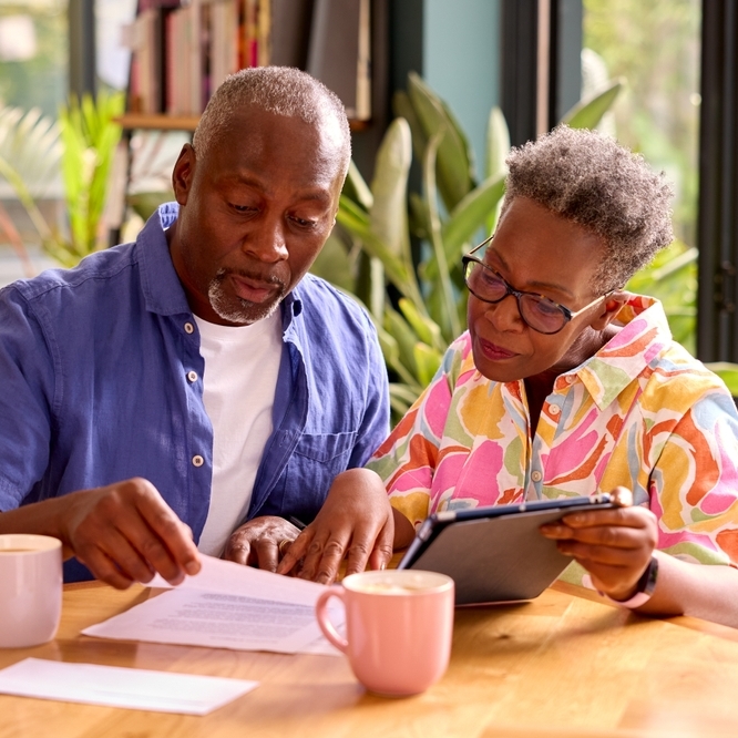 A photo of an older couple reviewing their finances