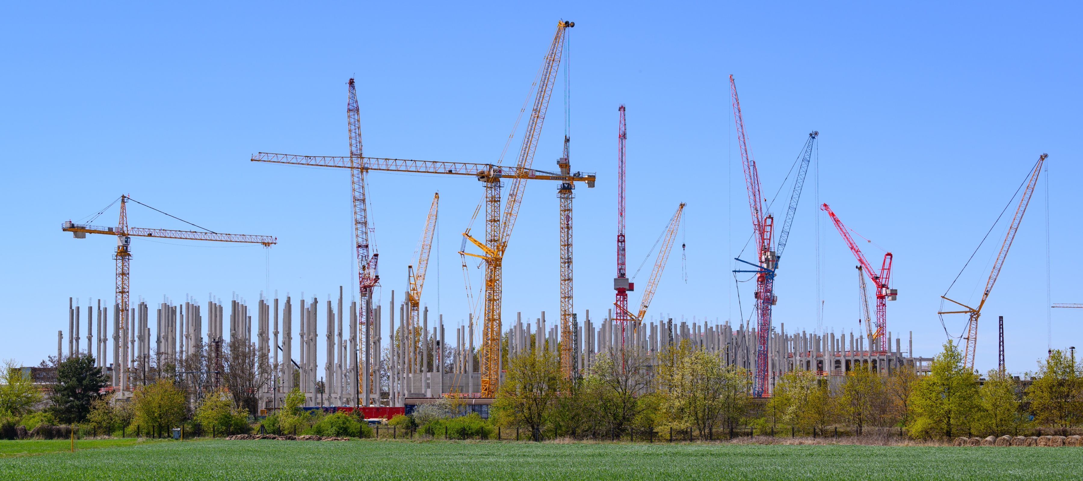 Several cranes stand on the large construction site for a Schwarz Group data center