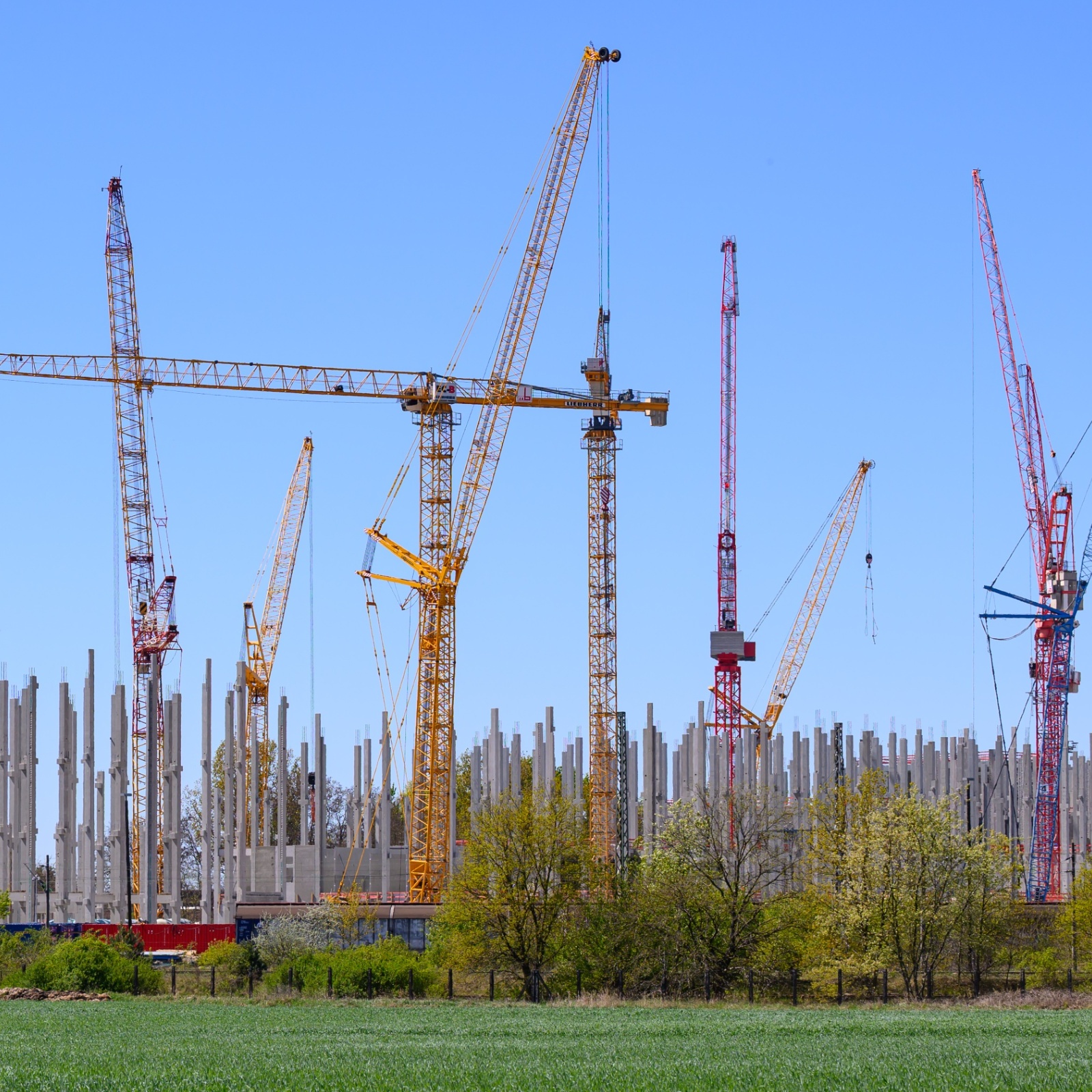 Several cranes stand on the large construction site for a Schwarz Group data center